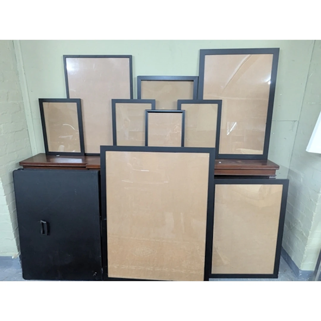 A collection of picture frames and presenters various sizes,...