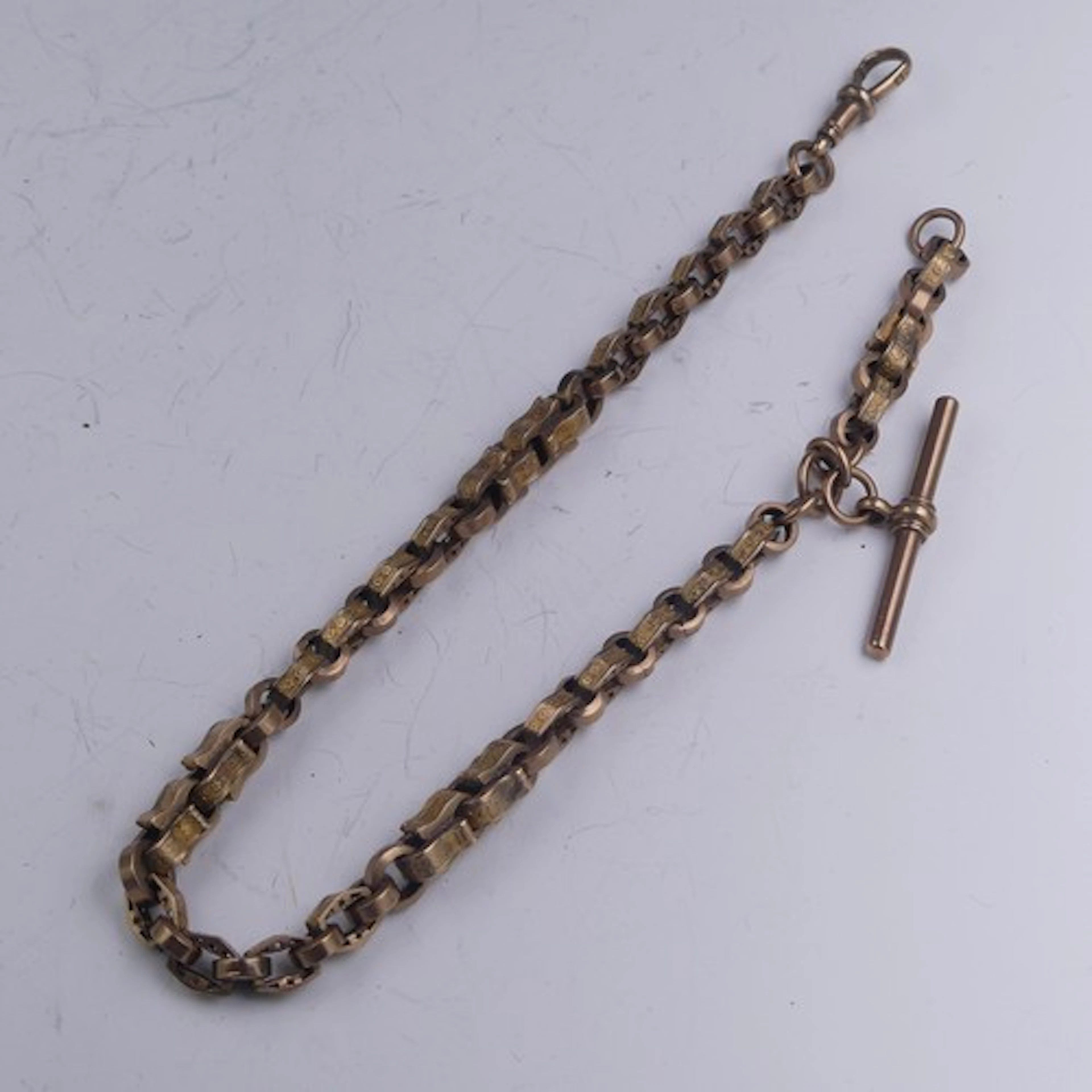 A Victorian 9ct gold Watch Chain, with a 'stars and bars' li...