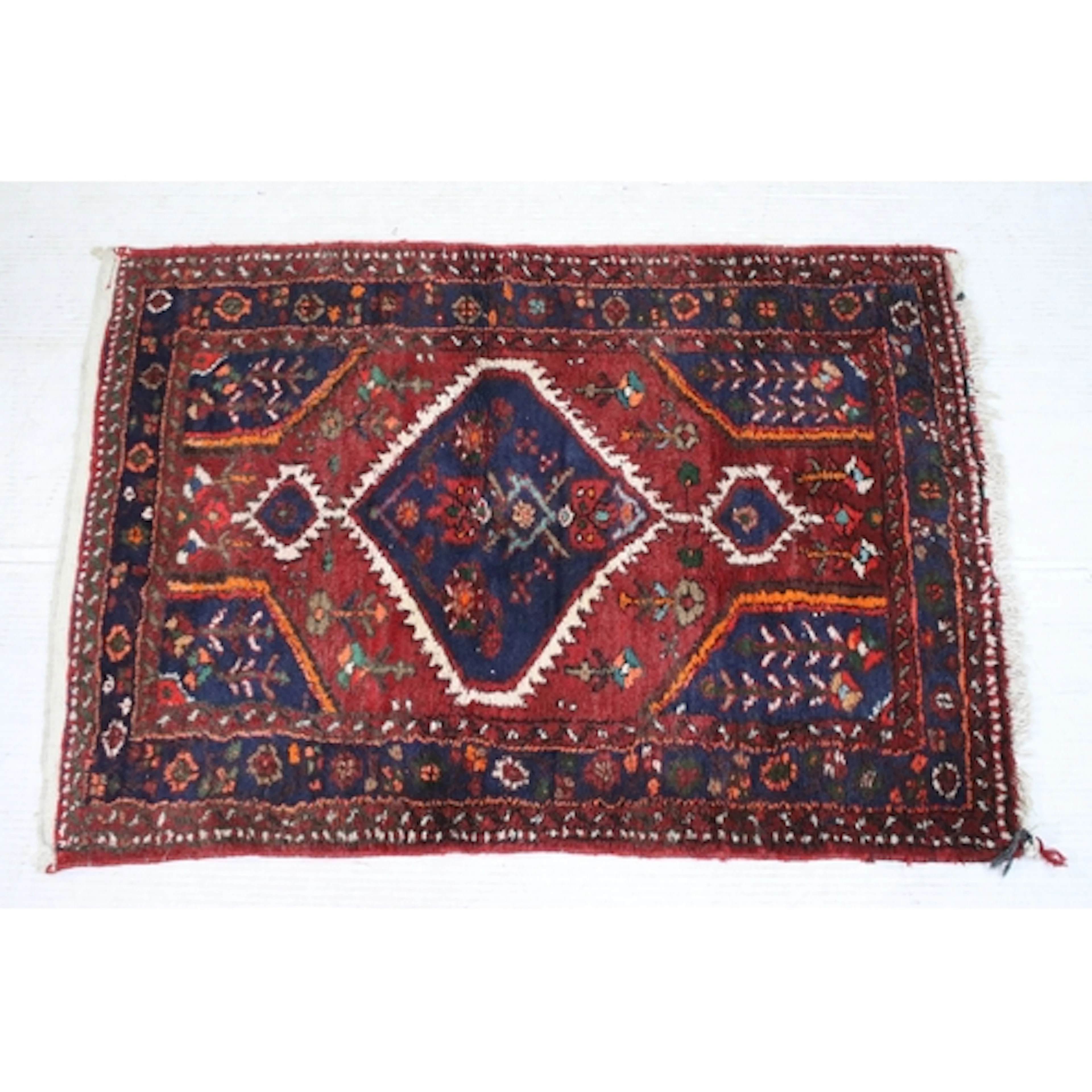 Hand-knotted red ground Hamadan rug, having central geometri...