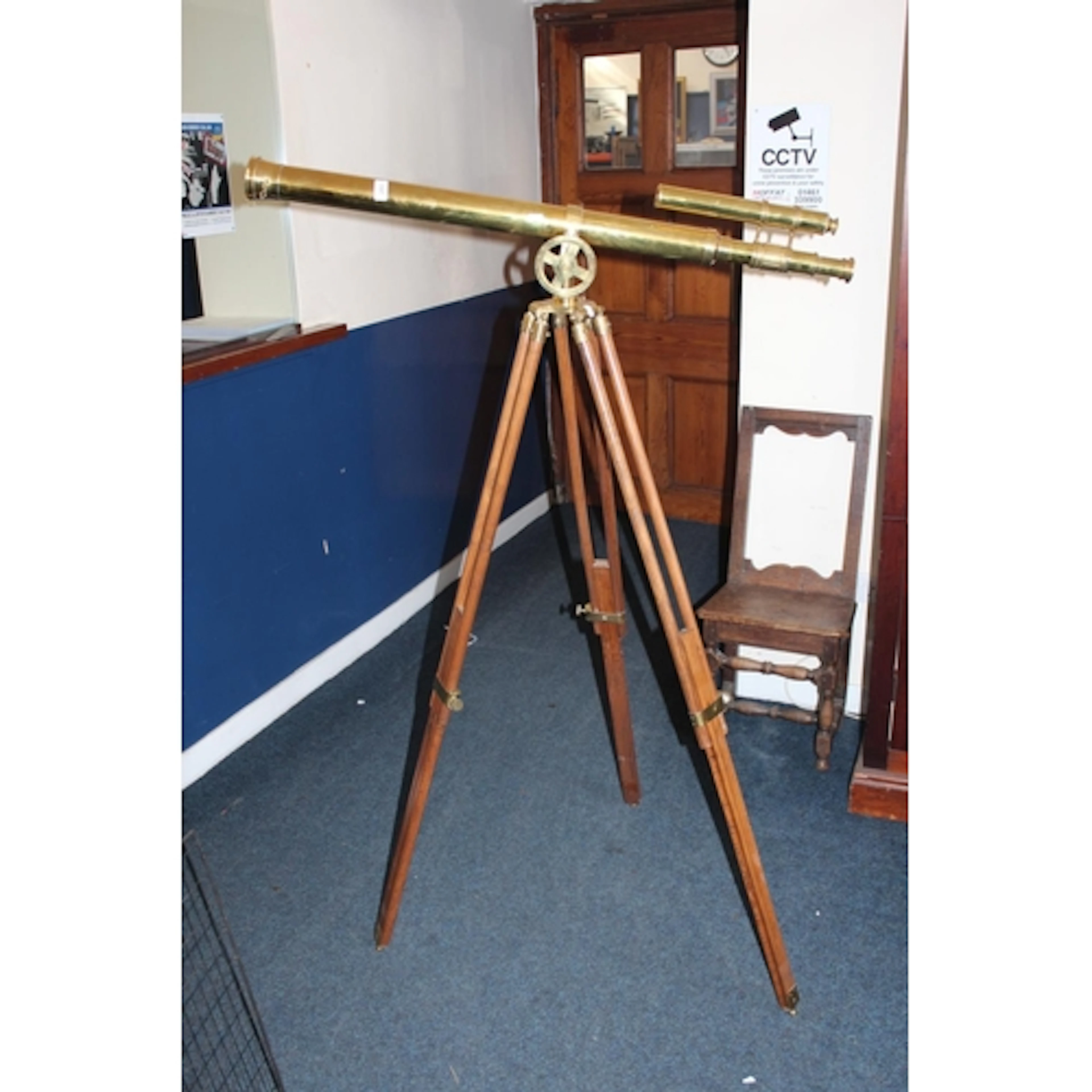 Vintage style brass telescope with eye finder on wooden trip...