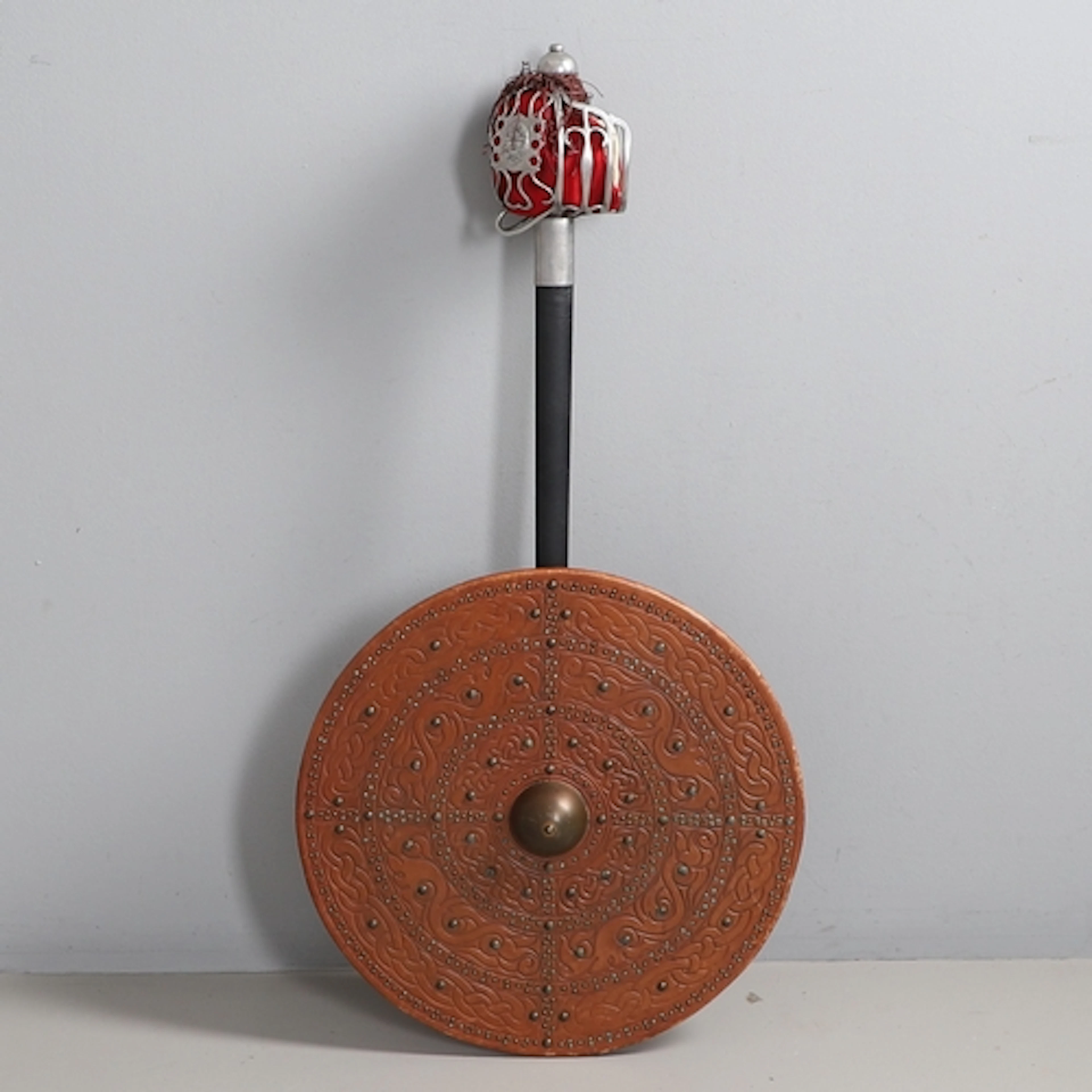 A REPLICA OF AN 18TH CENTURY BASKET HILTED SWORD AND SCABBAR...