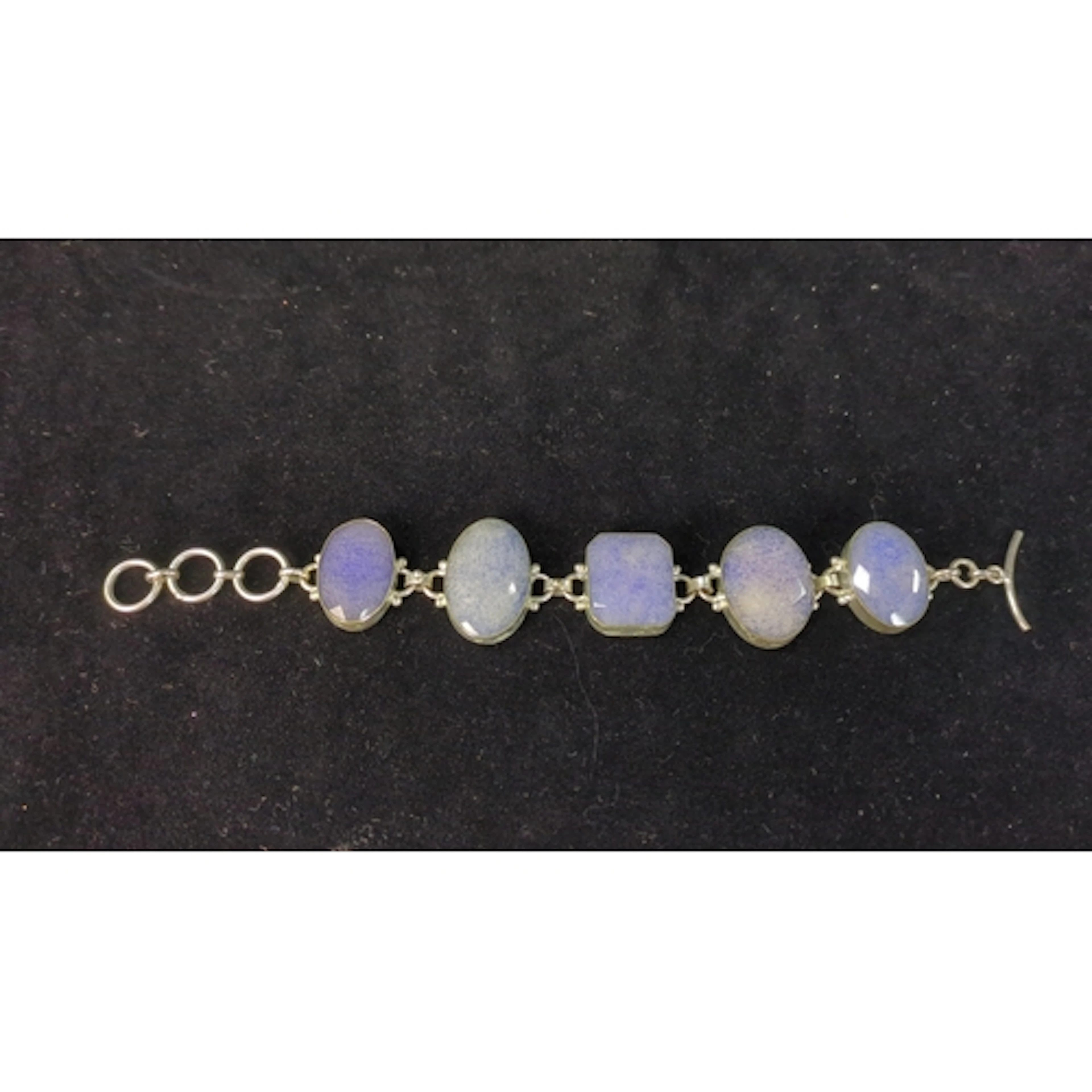 Sterling silver bracelet set with five bezel-set mottled vio...