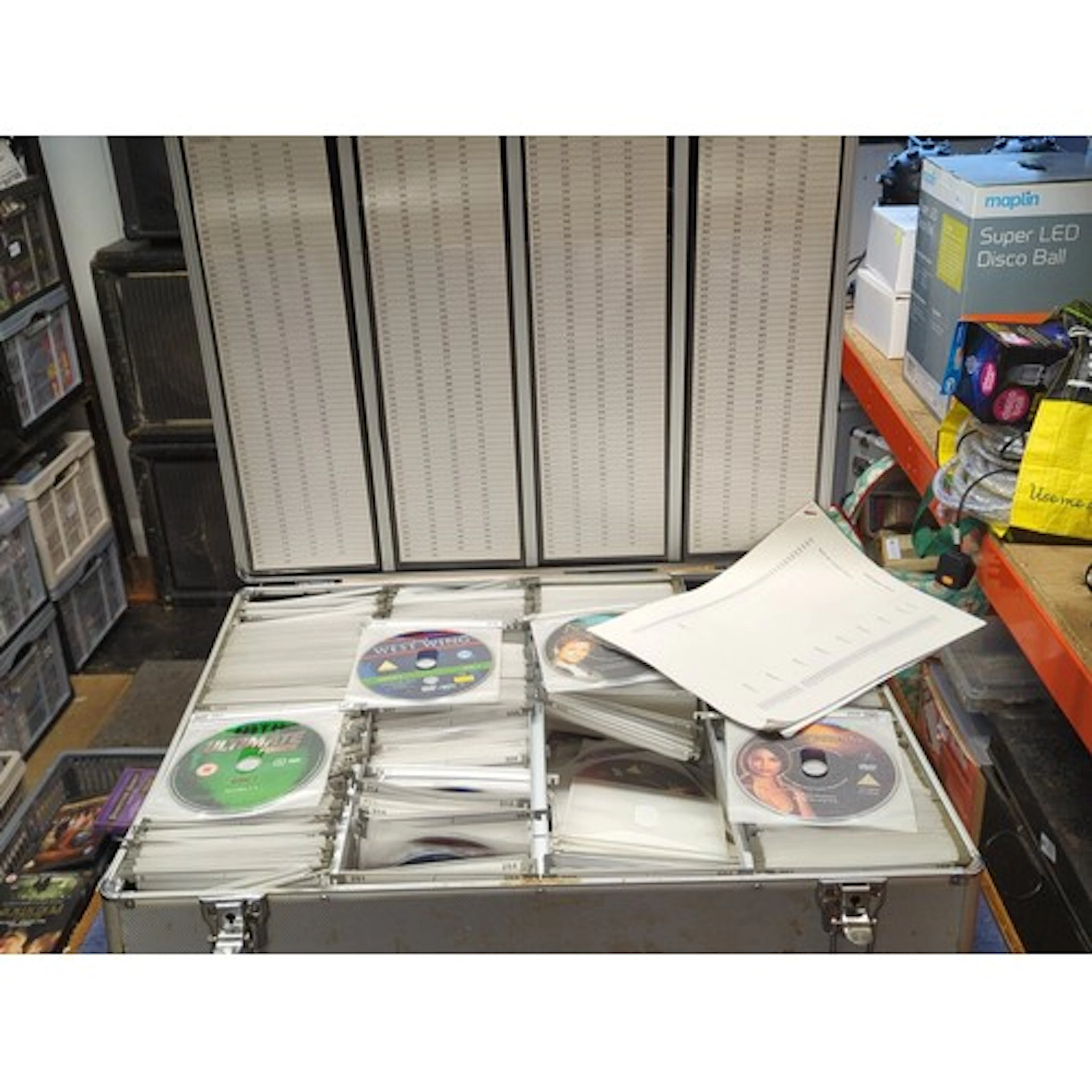 A group of DVD-Video discs in sleeves, housed in an aluminiu...