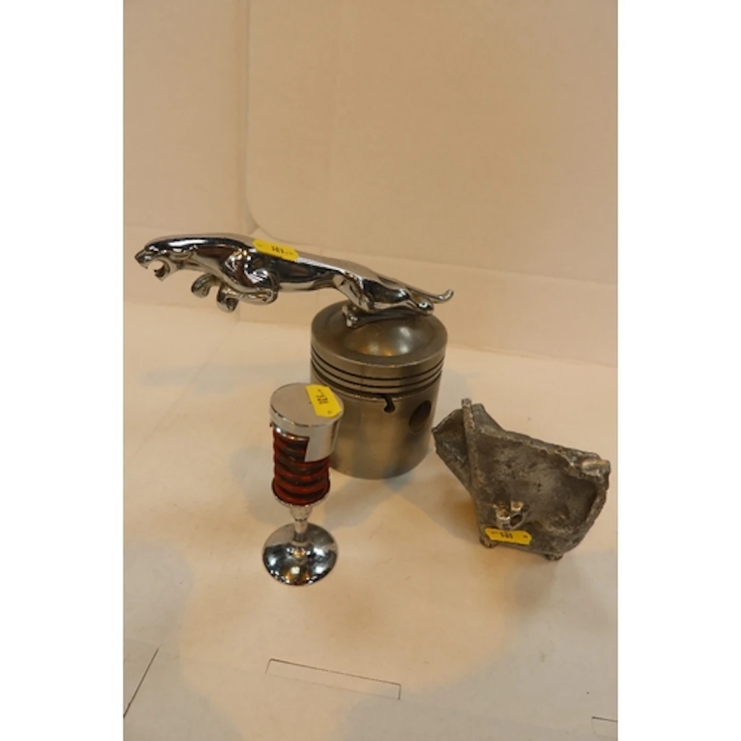 Jaguar model on piston, valve part of a Jag engine that fa...