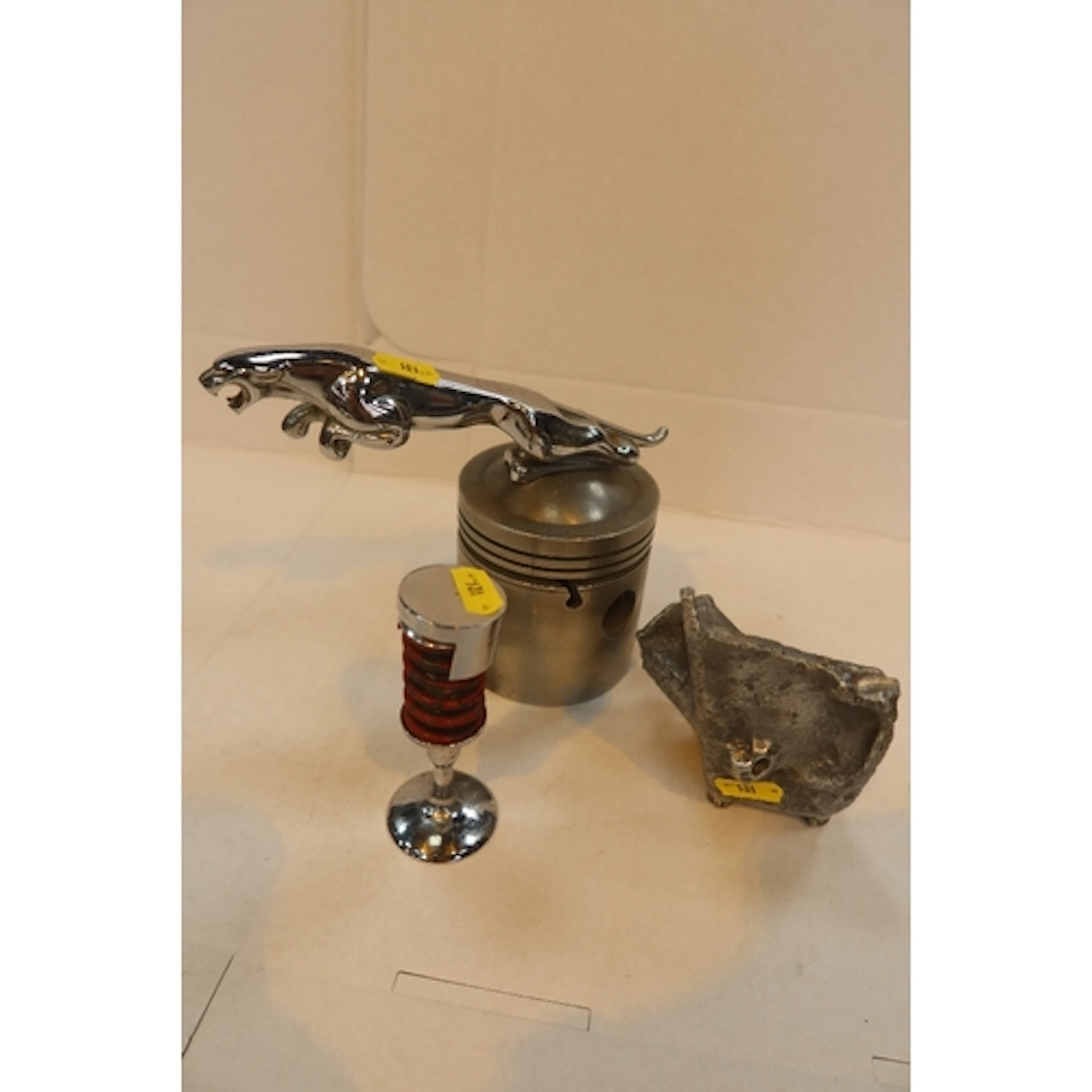 Jaguar model on piston, valve part of a Jag engine that fa...
