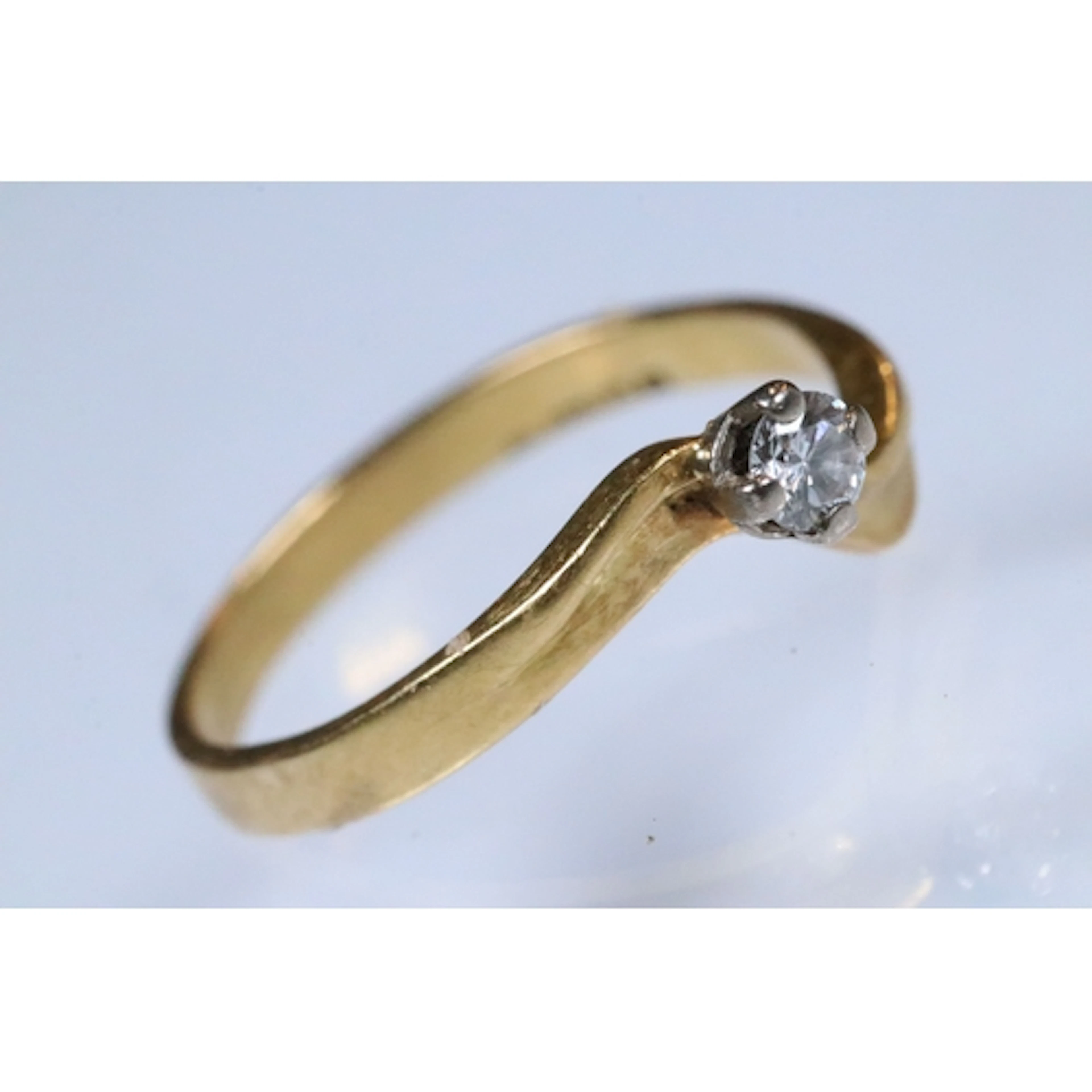 18ct gold and diamond ring. The ring being set with a round ...