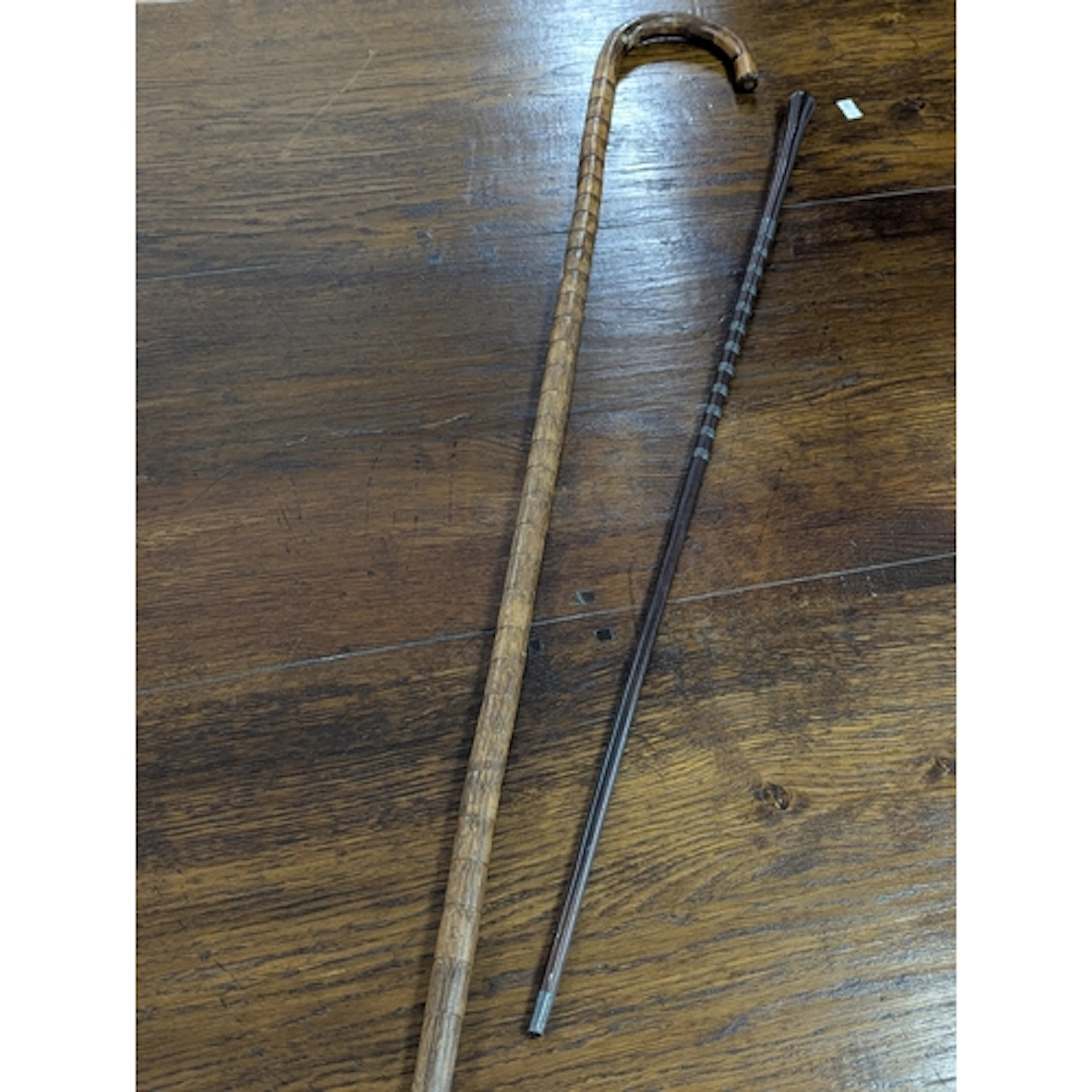 A bamboo walking stick together with a Swagger stick, mounte...