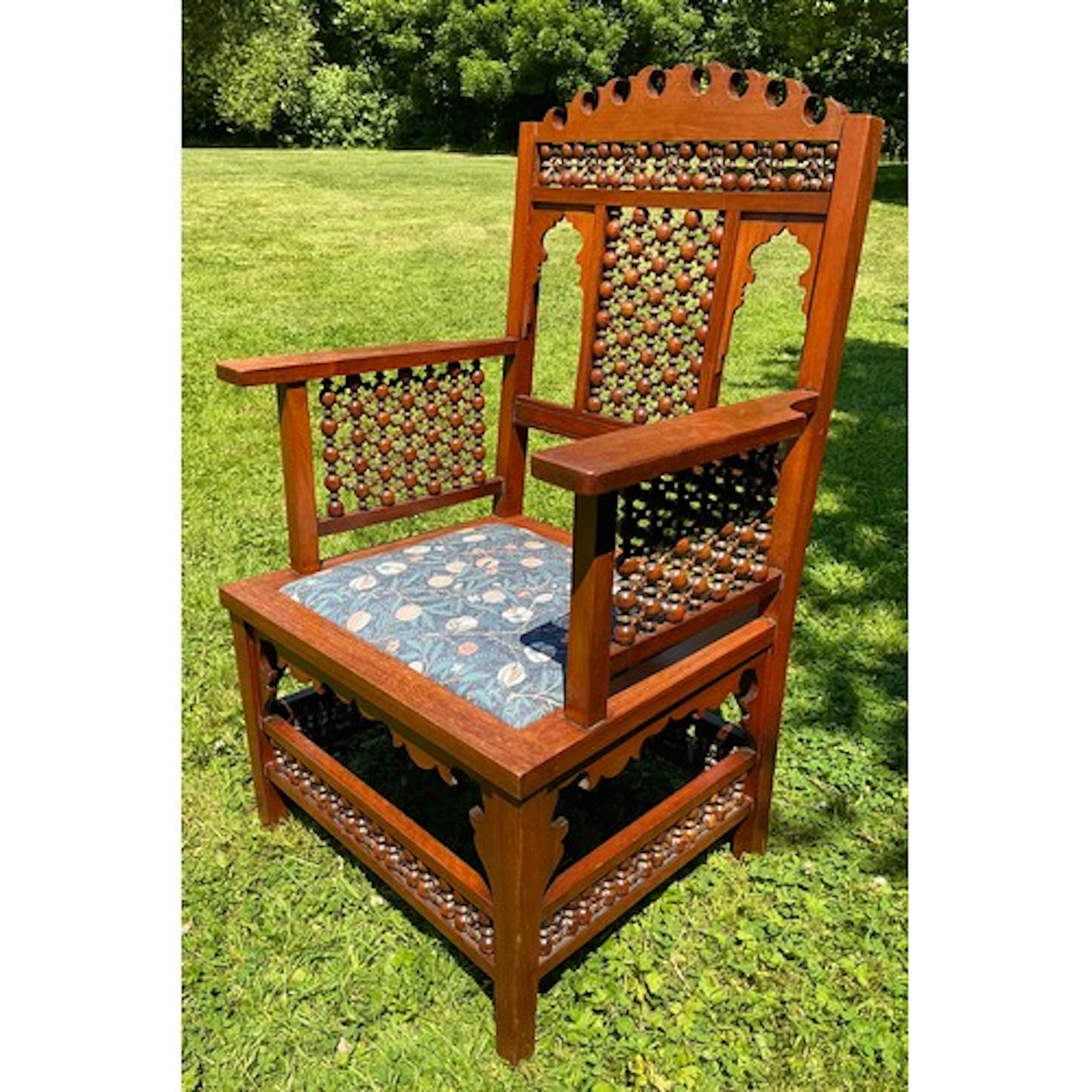 An Arts and Crafts, Anglo-moorish style walnut armchair, for...
