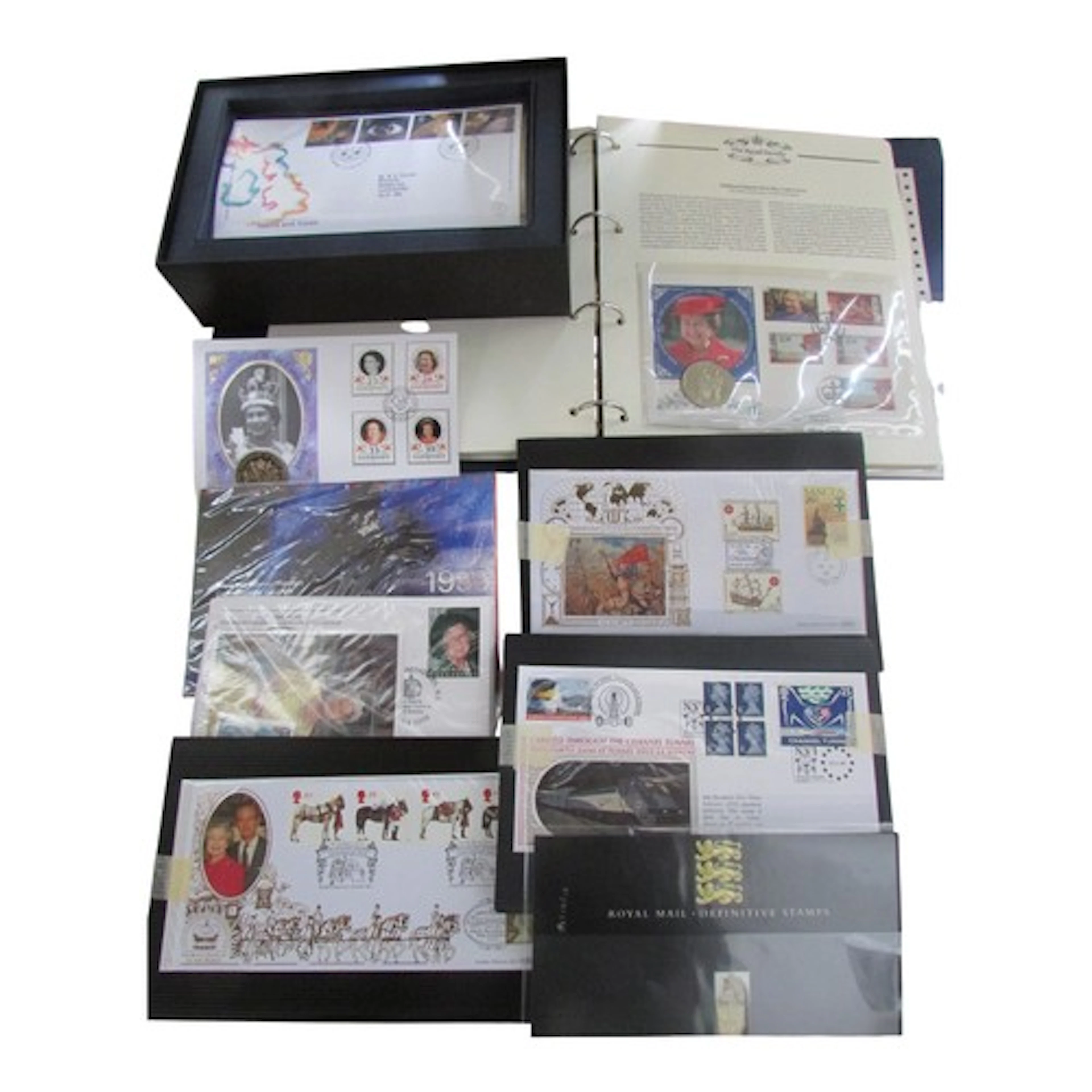 A folio containing a coin and stamp collection commemorating...