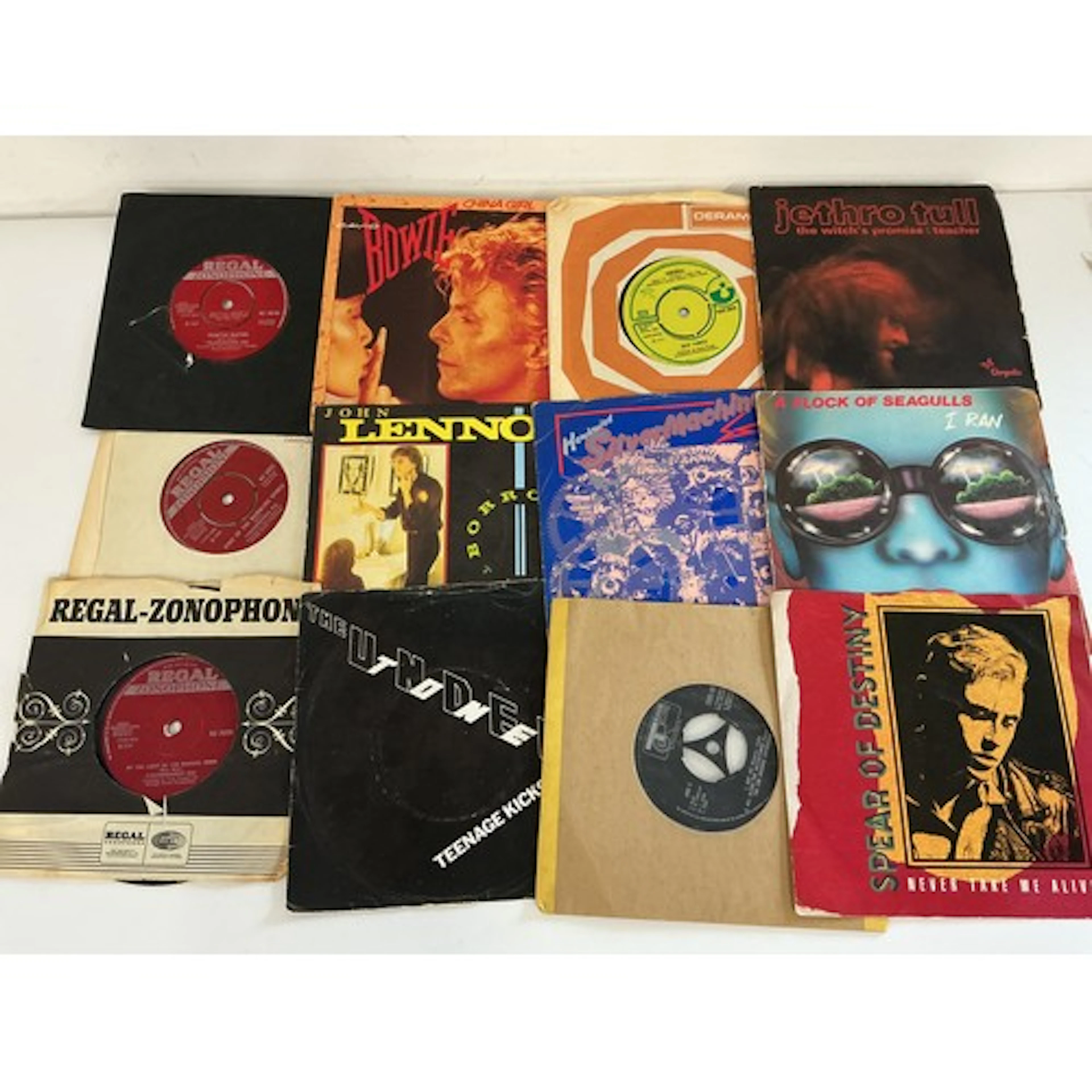 A collection of 7” singles by various artists including earl...