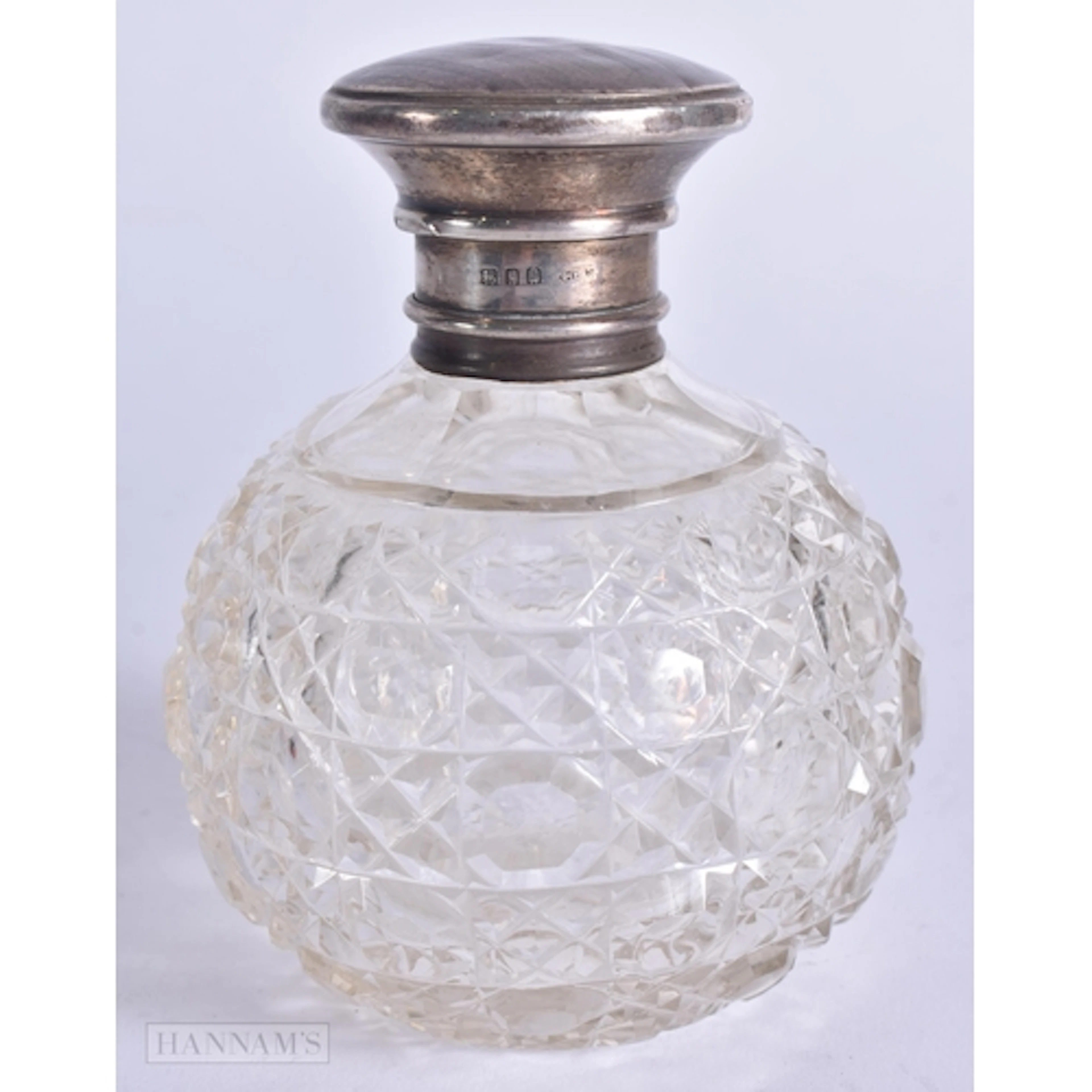 AN ANTIQUE SILVER MOUNTED CUT GLASS SCENT BOTTLE. 11 cm high...