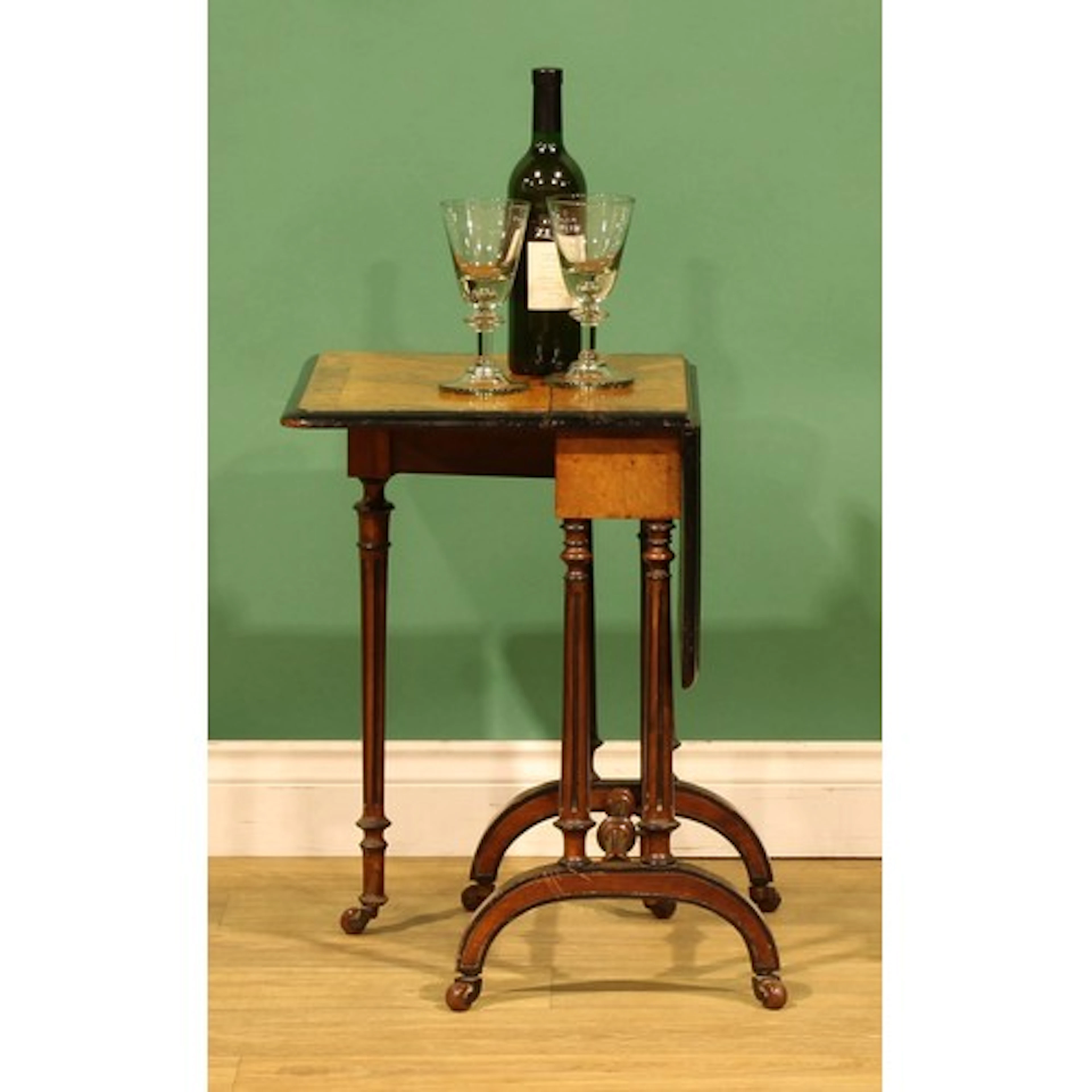 A Victorian walnut and parcel-ebonised Sutherland table, of ...