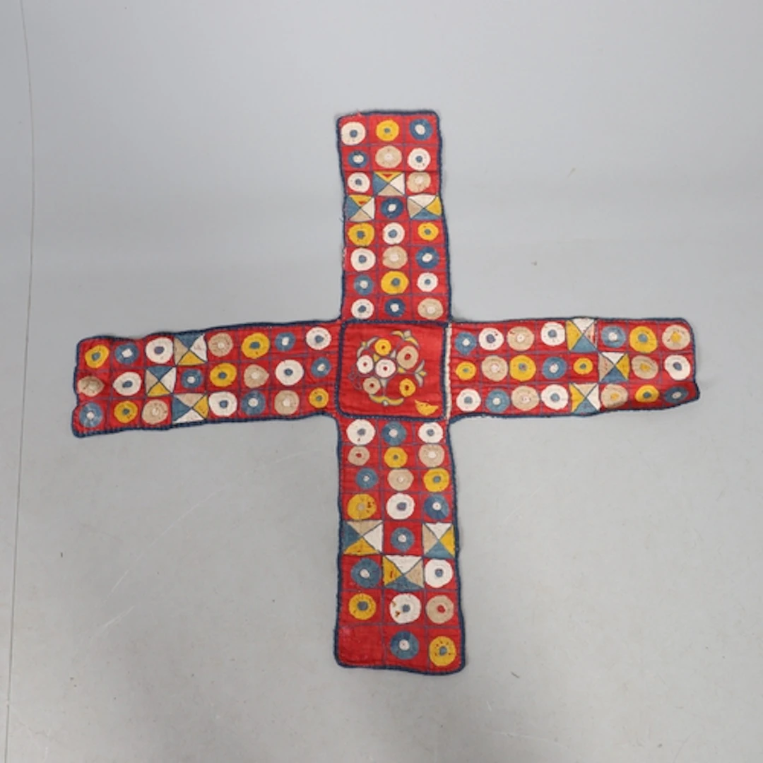 A CROSS SHAPED PANEL OF FABRIC, KNOWN AS A CHAUPAR OR CHAUSA...