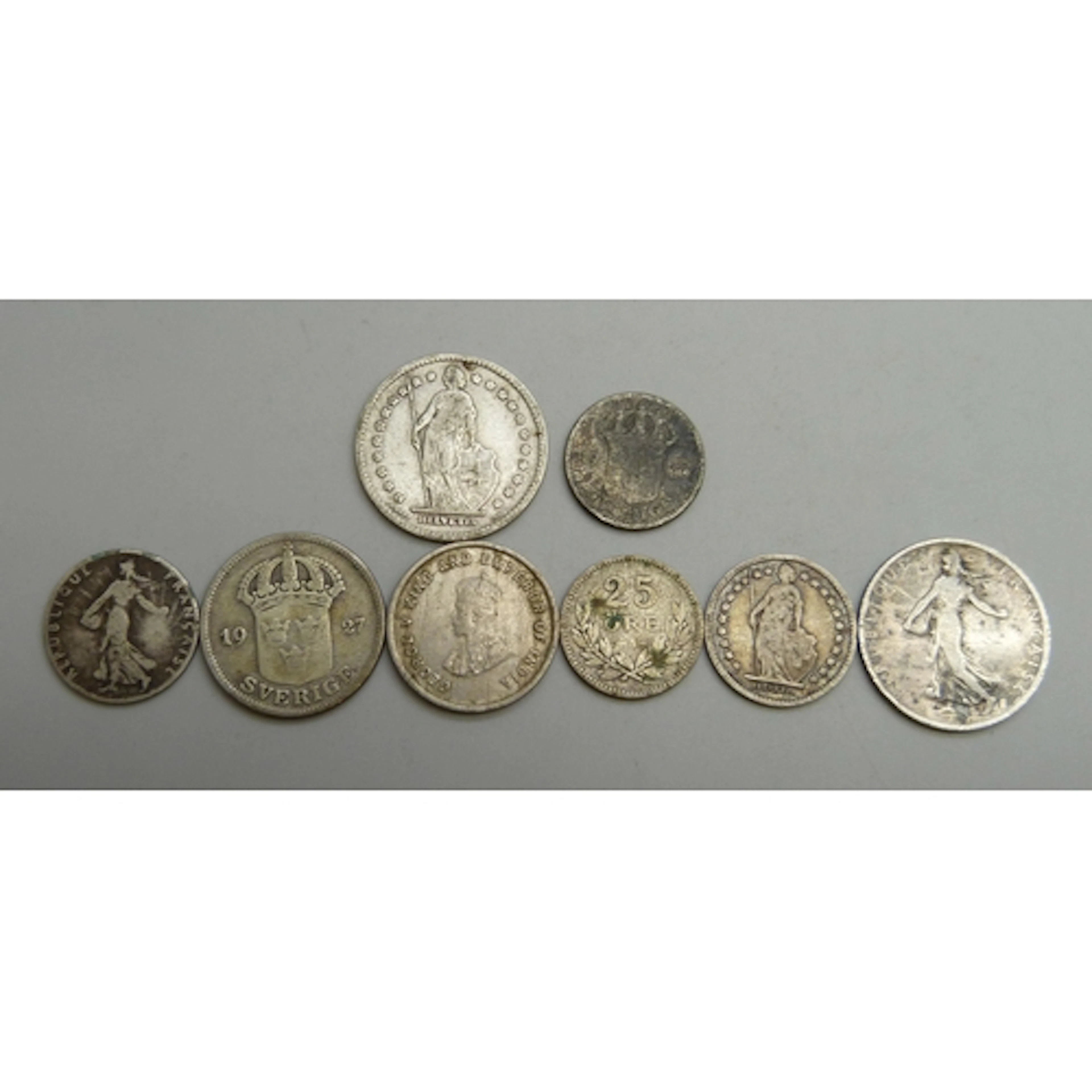 A collection of coins including Sweden, France, and Switzerl...