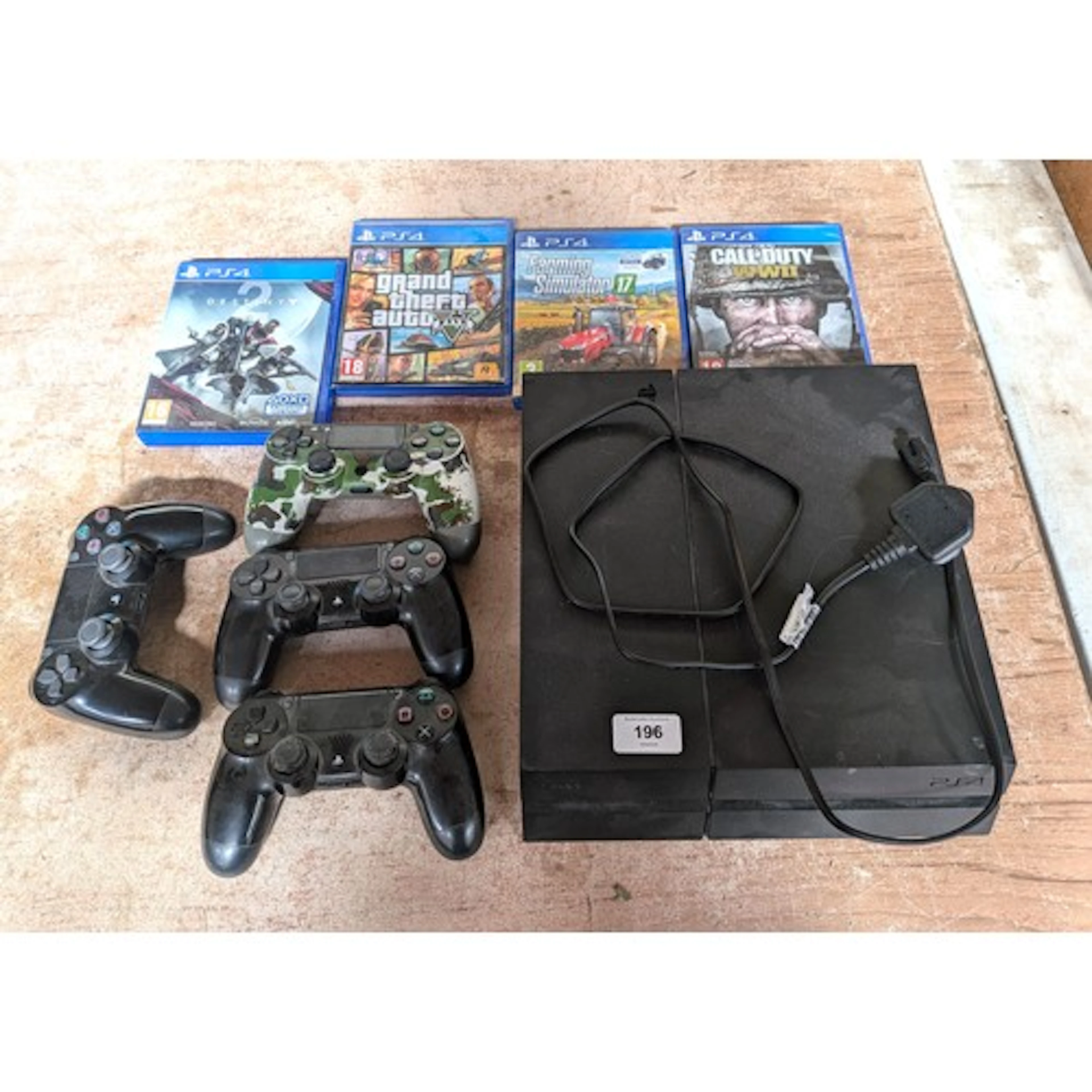 A Sony Playstation 4 console with four various games and fou...