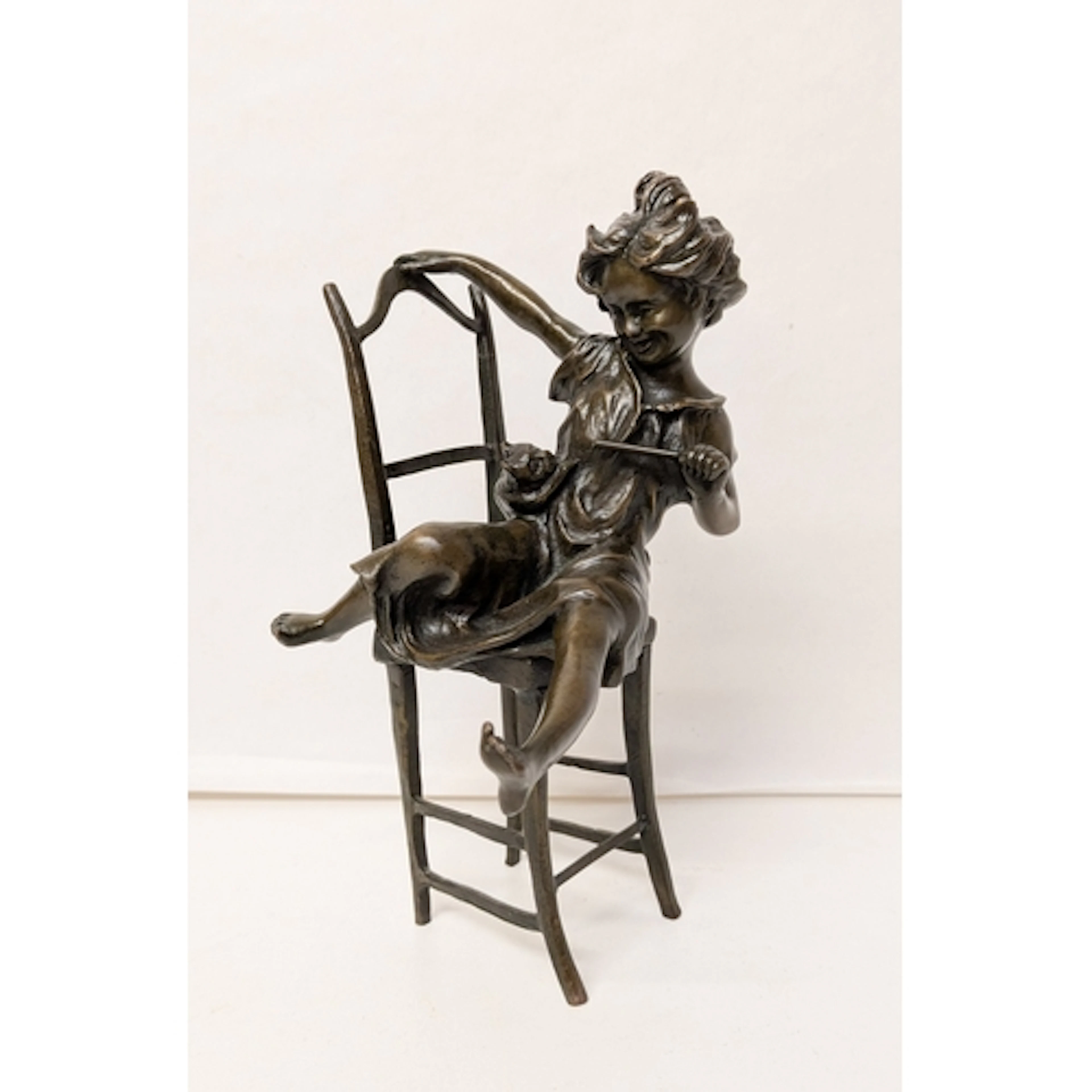 Jolie Cat - bronze figurine of a young girl playing with a k...