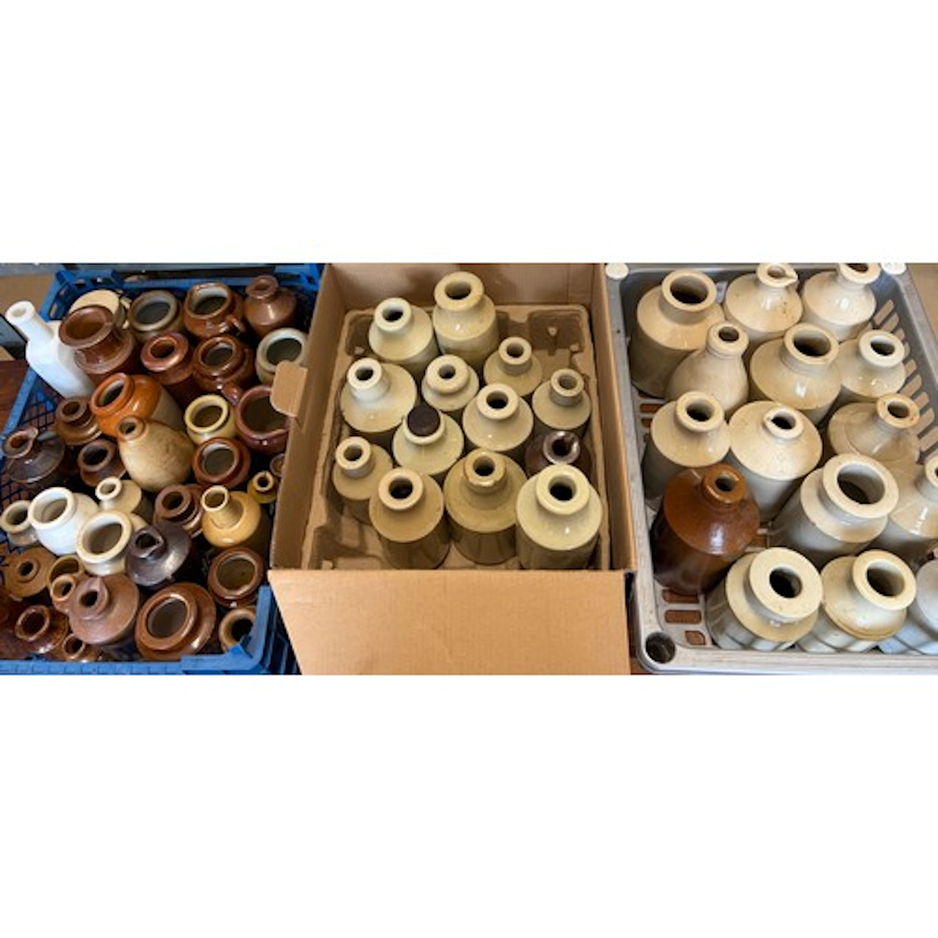 Large collection of stoneware bottles.