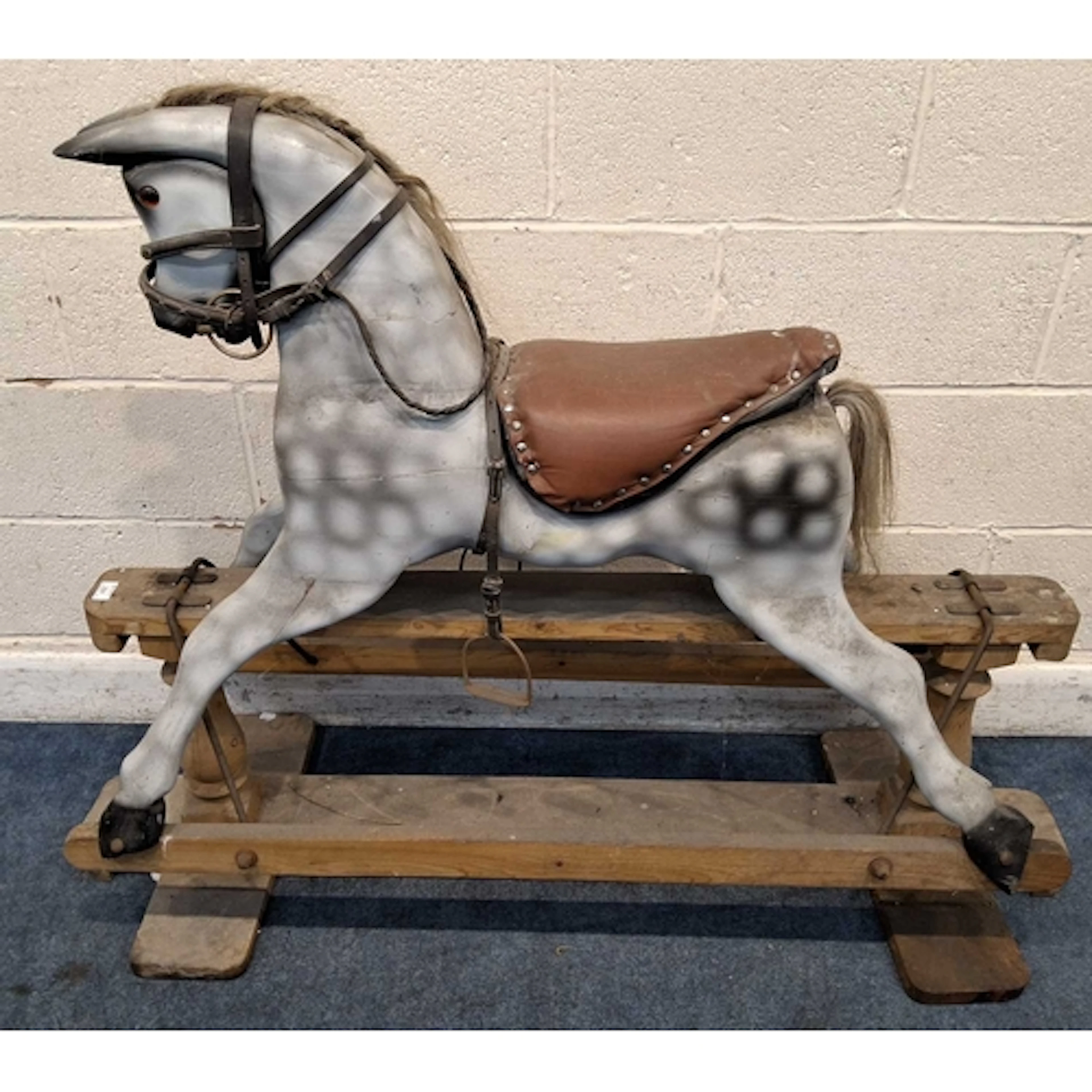 AN EARLY 20TH CENTURY DAPPLE PAINTED TIMBER ROCKING HORSE, w...