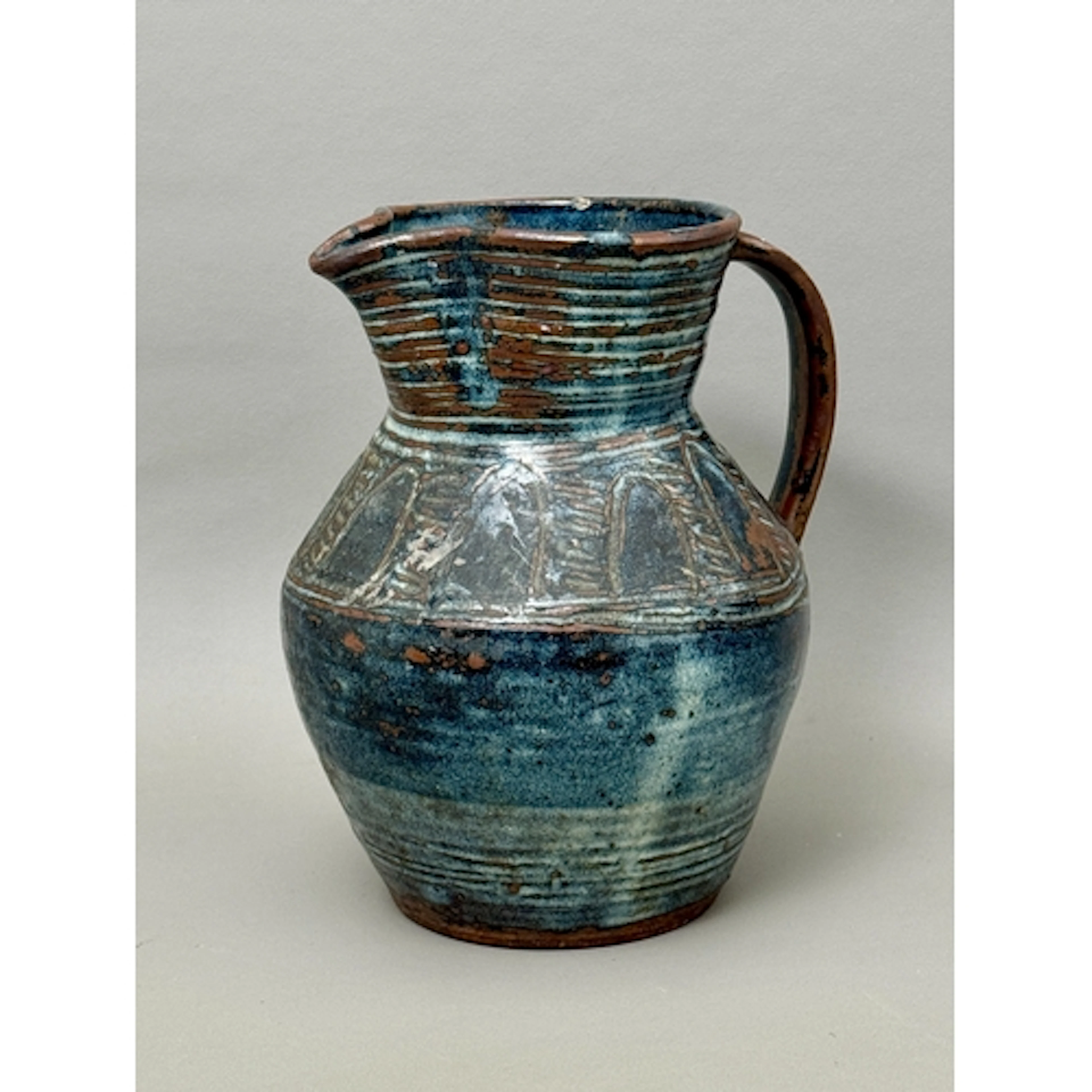 A hand thrown and blue glazed pitcher by Hassan Lapai for Ab...