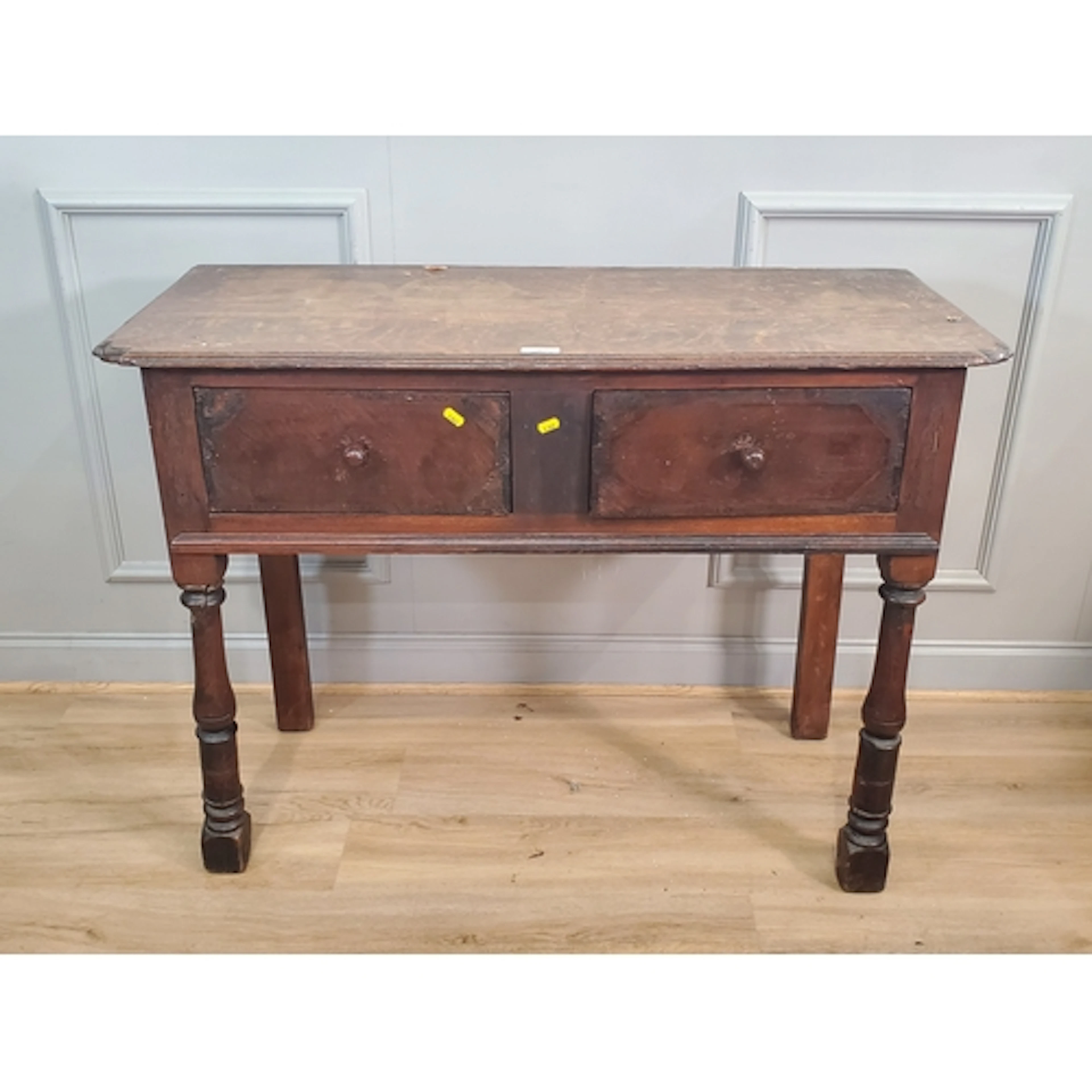 An oak side Table fitted two short drawers raised on tall tu...