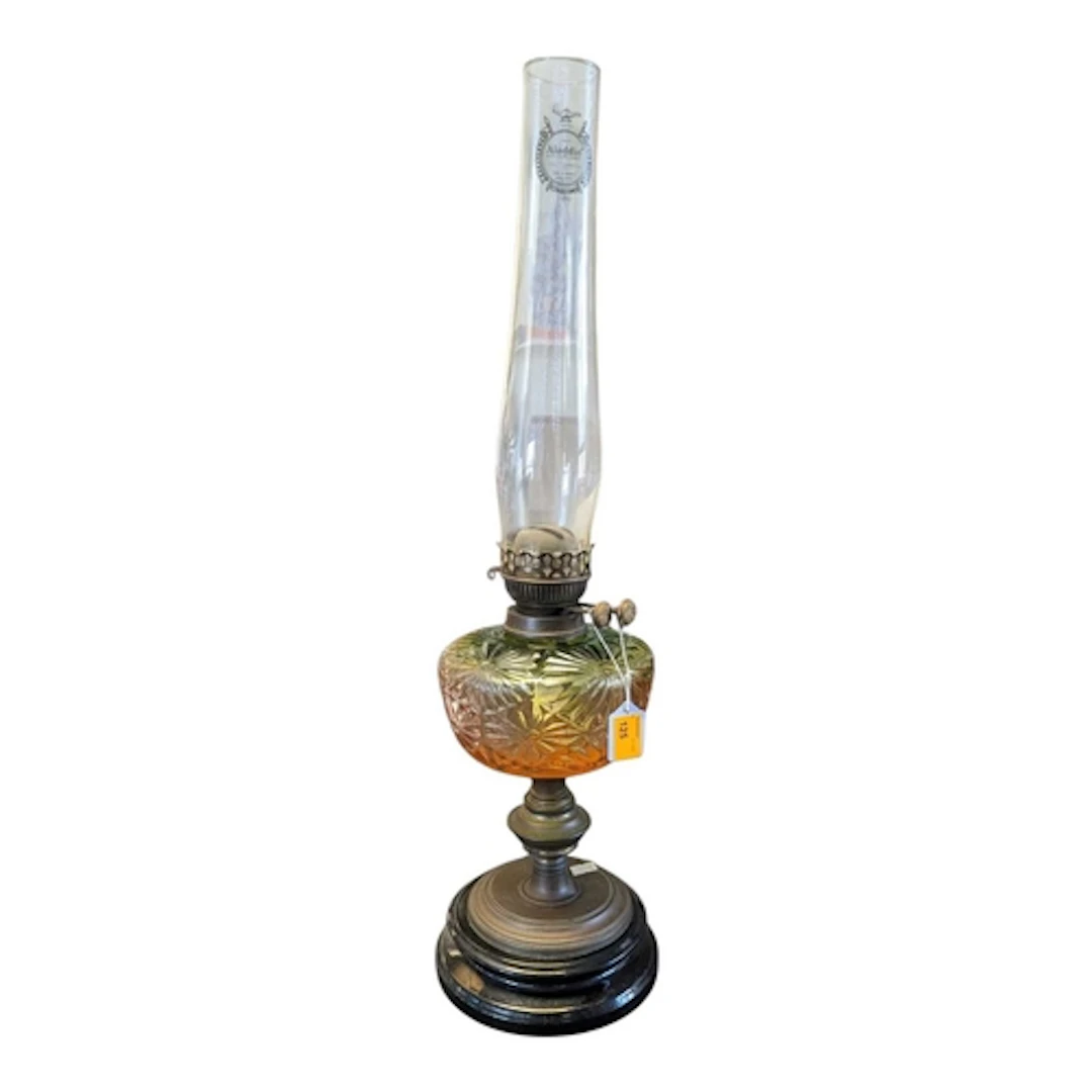 An early 20th century glass oil lamp. The lamp with green an...