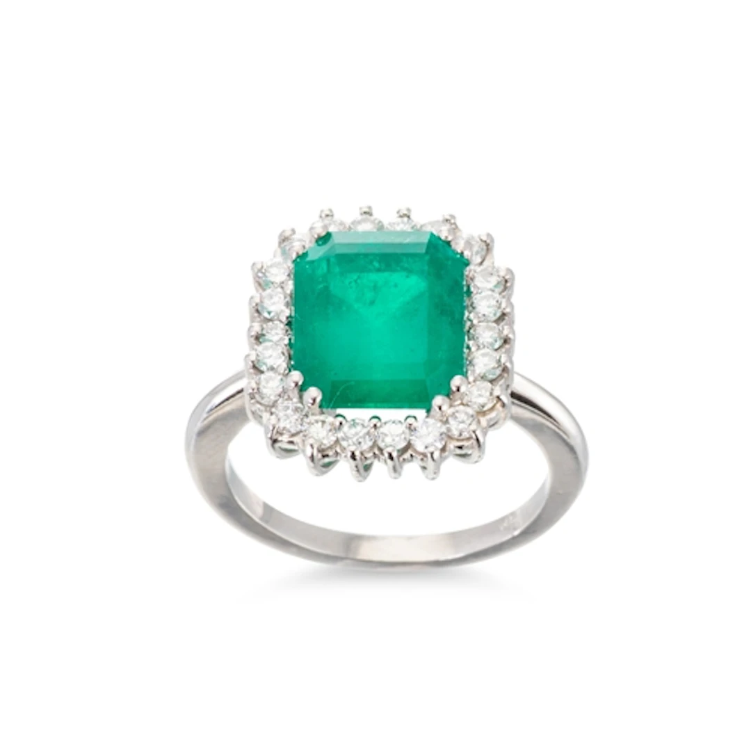 AN IMPRESSIVE EMERALD AND DIAMOND CLUSTER RING, the emerald ...