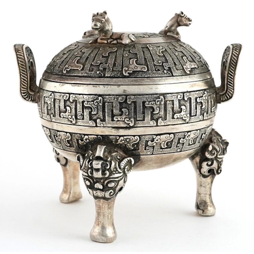 Chinese white metal lidded tripod censer decorated with anim...