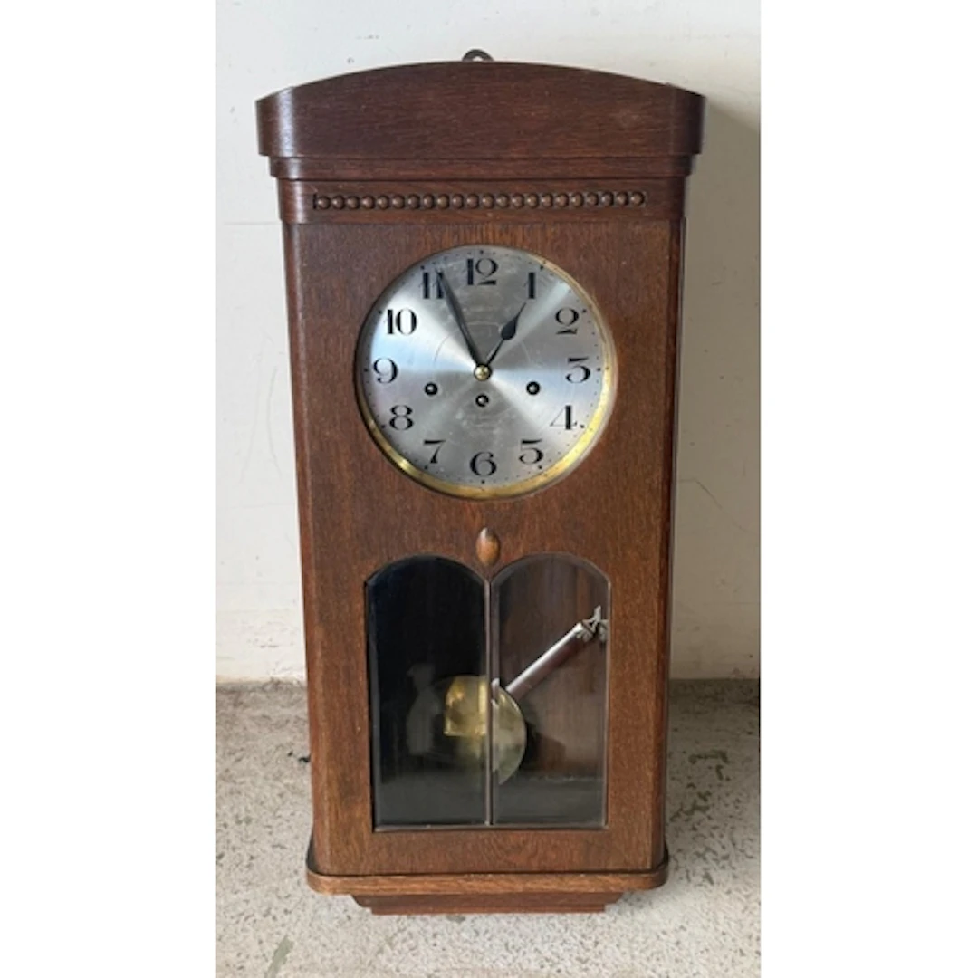An eight day oak regulator wall clock