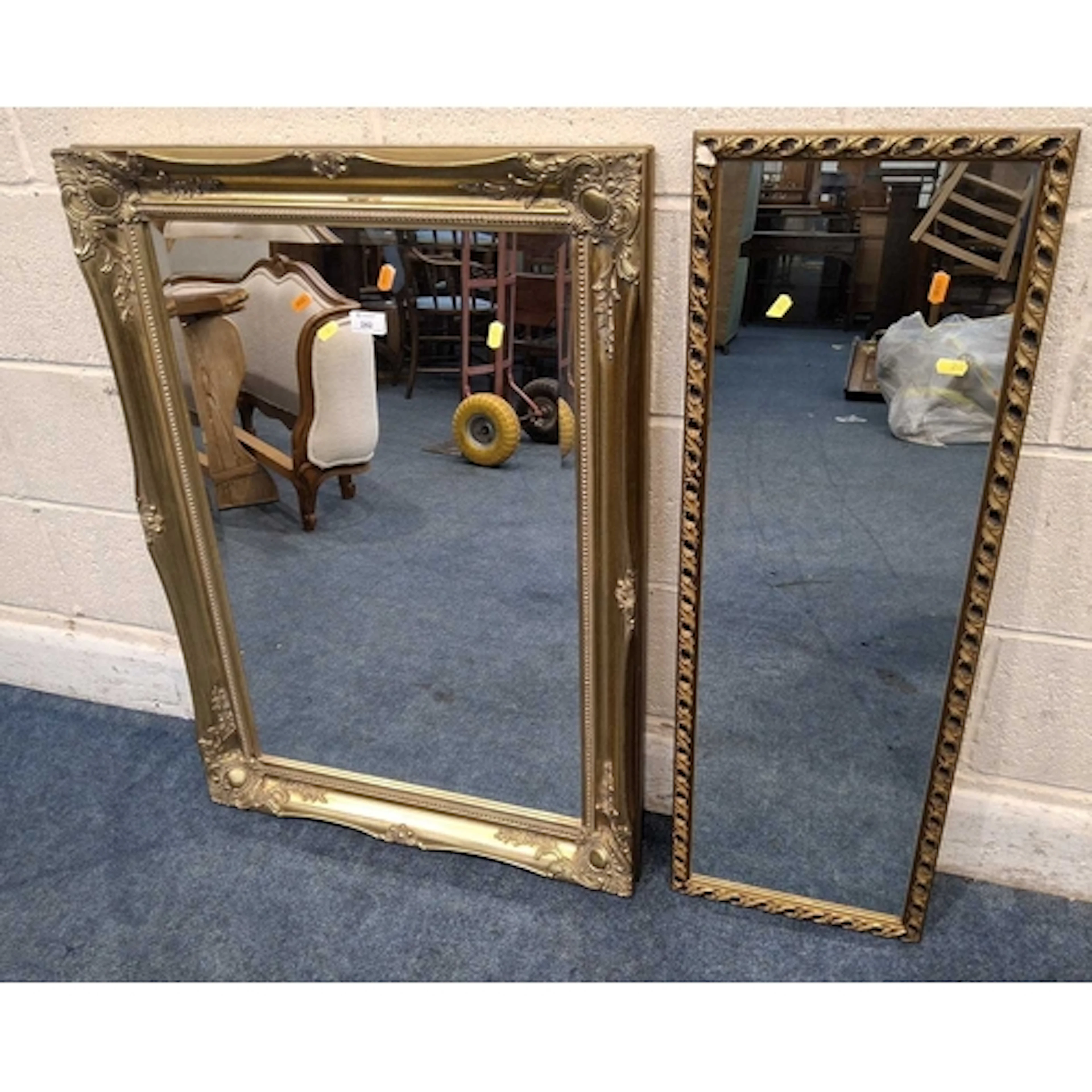 A GILT WOOD RECTANGULAR BEVELLED EDGE WALL MIRROR, with scro...