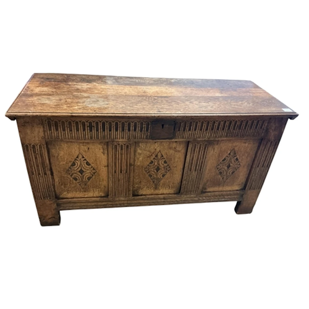 A carved oak panelled coffer, width 130cm, depth 50cm, heigh...