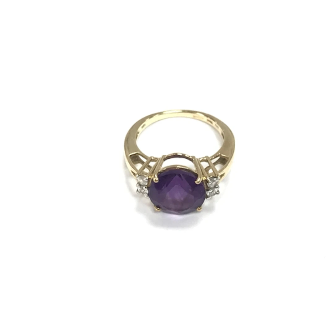 A 9ct gold ring set with a purple stone. Size L 1/2 and 3.2g