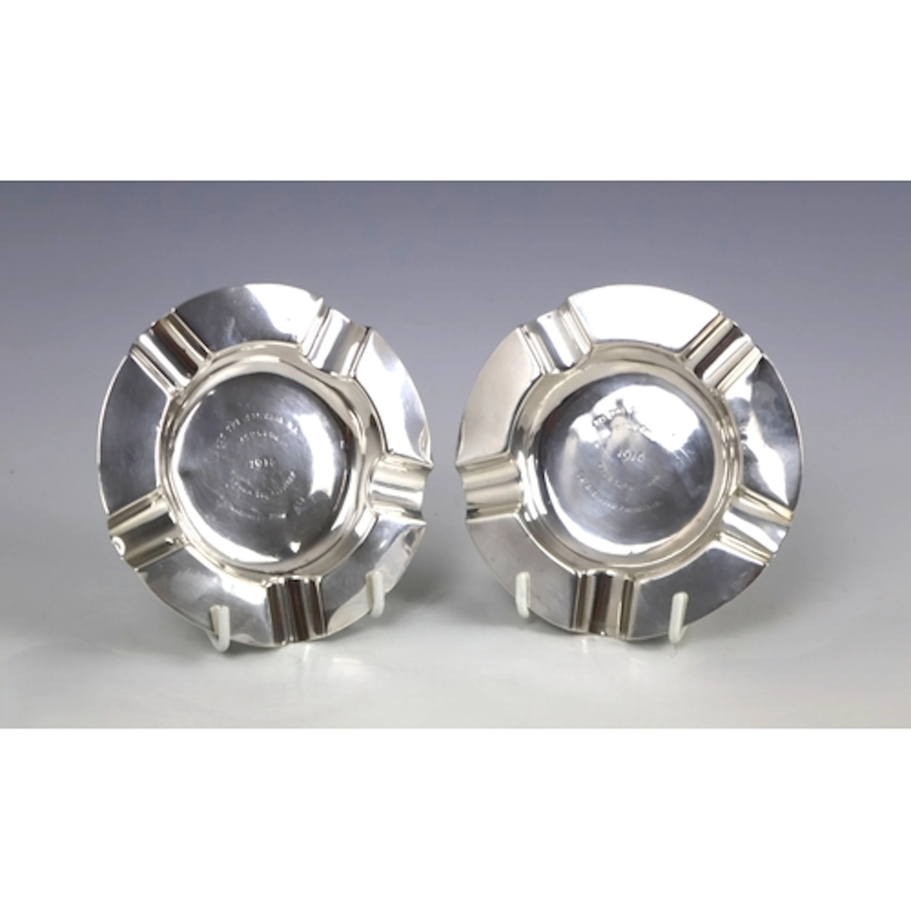 A pair of silver ashtrays engraved 'To the Officers RA Athlo...