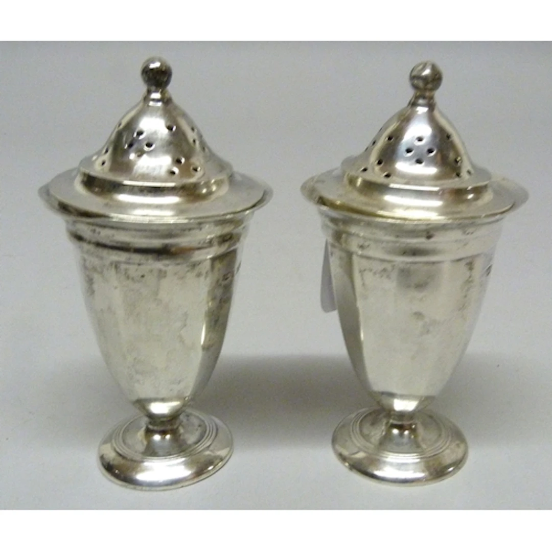 Pair of George V silver domed shaped pepper pots with covers...