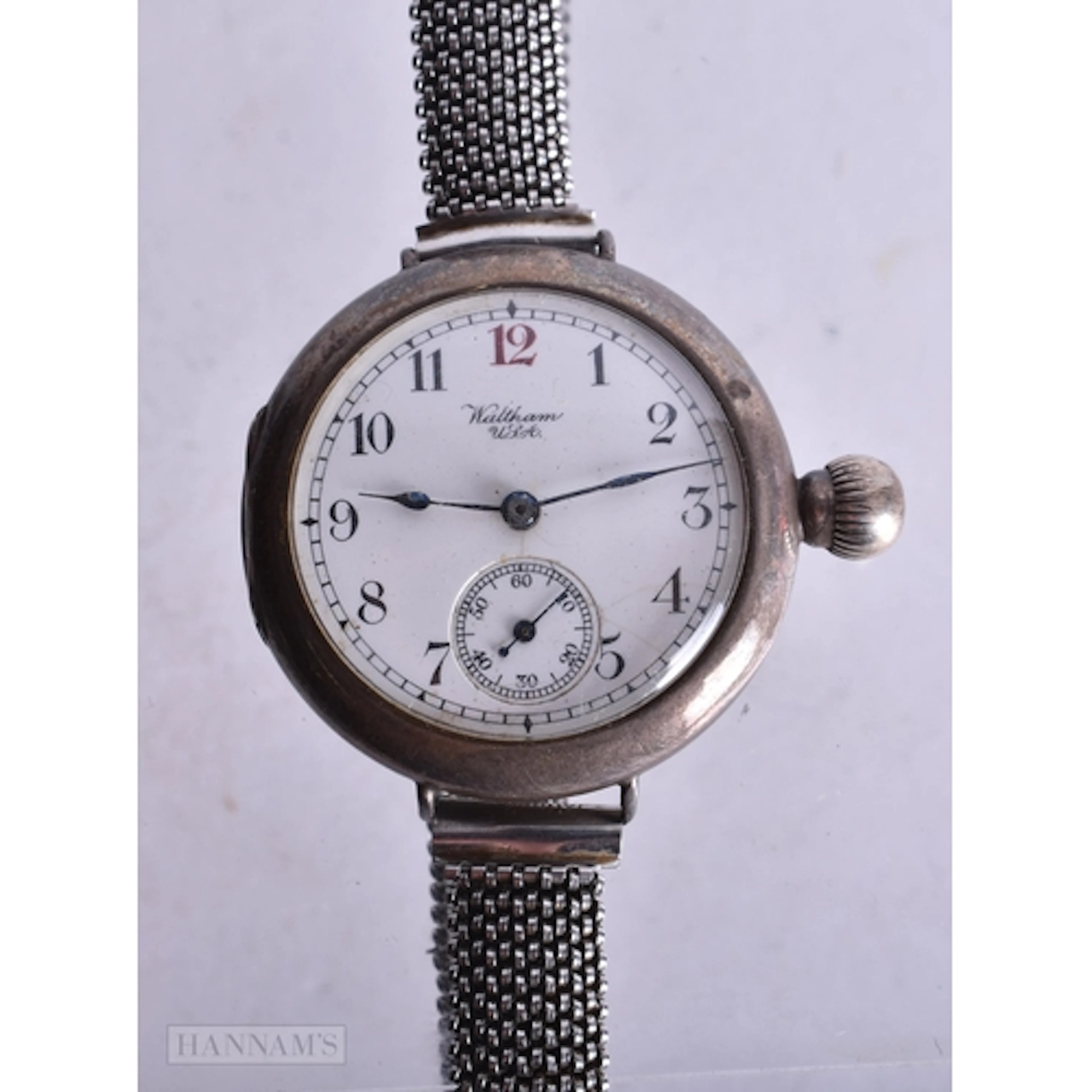 A WALTHAM SILVER TRENCH WATCH. Not running. 3.25 cm wide.