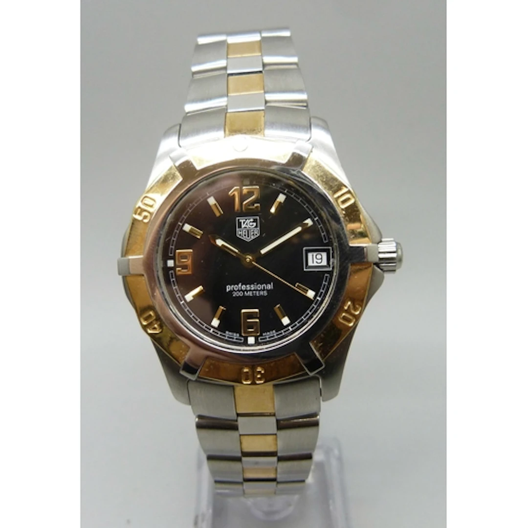 A Tag Heuer Professional wristwatch with black dial and date...
