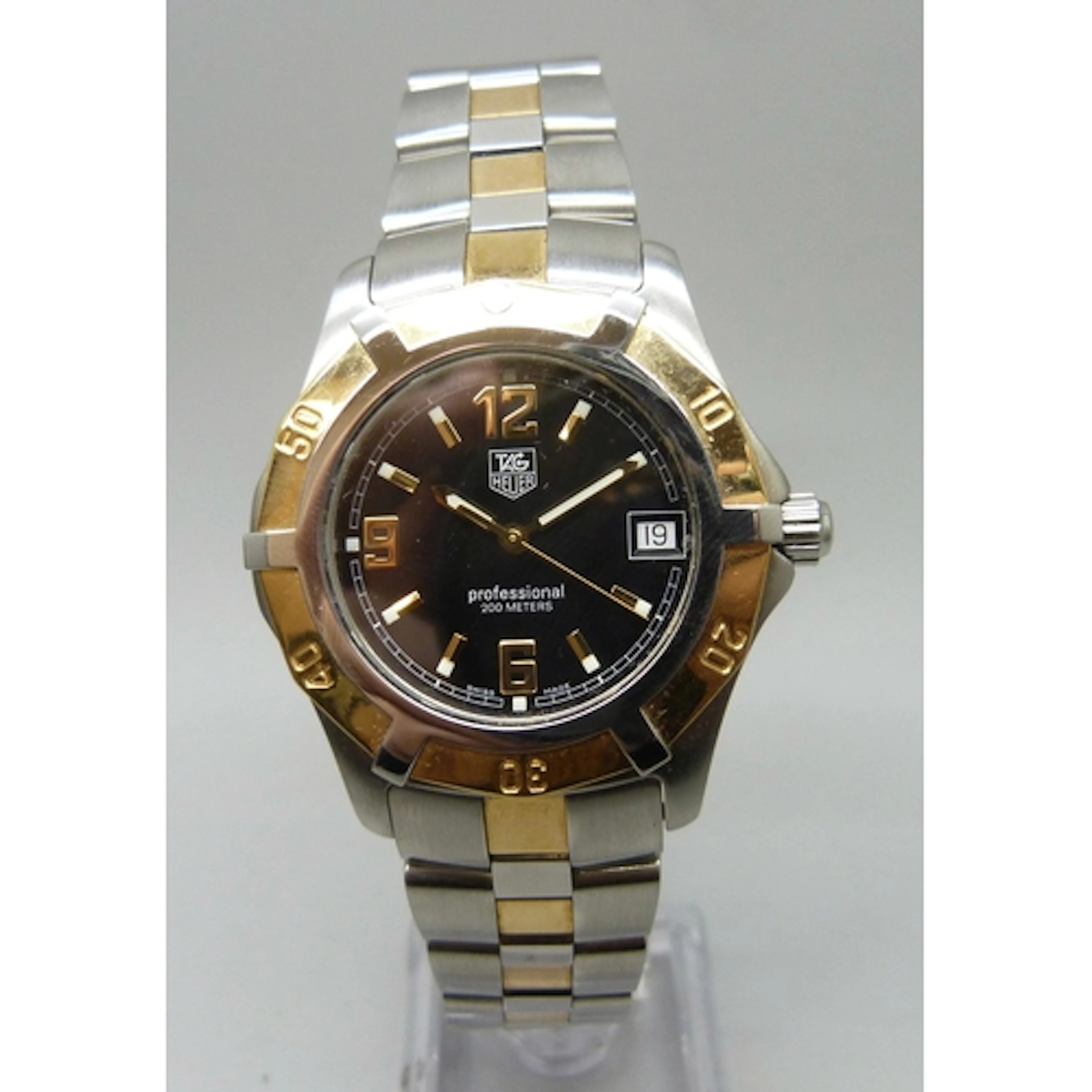 A Tag Heuer Professional wristwatch with black dial and date...
