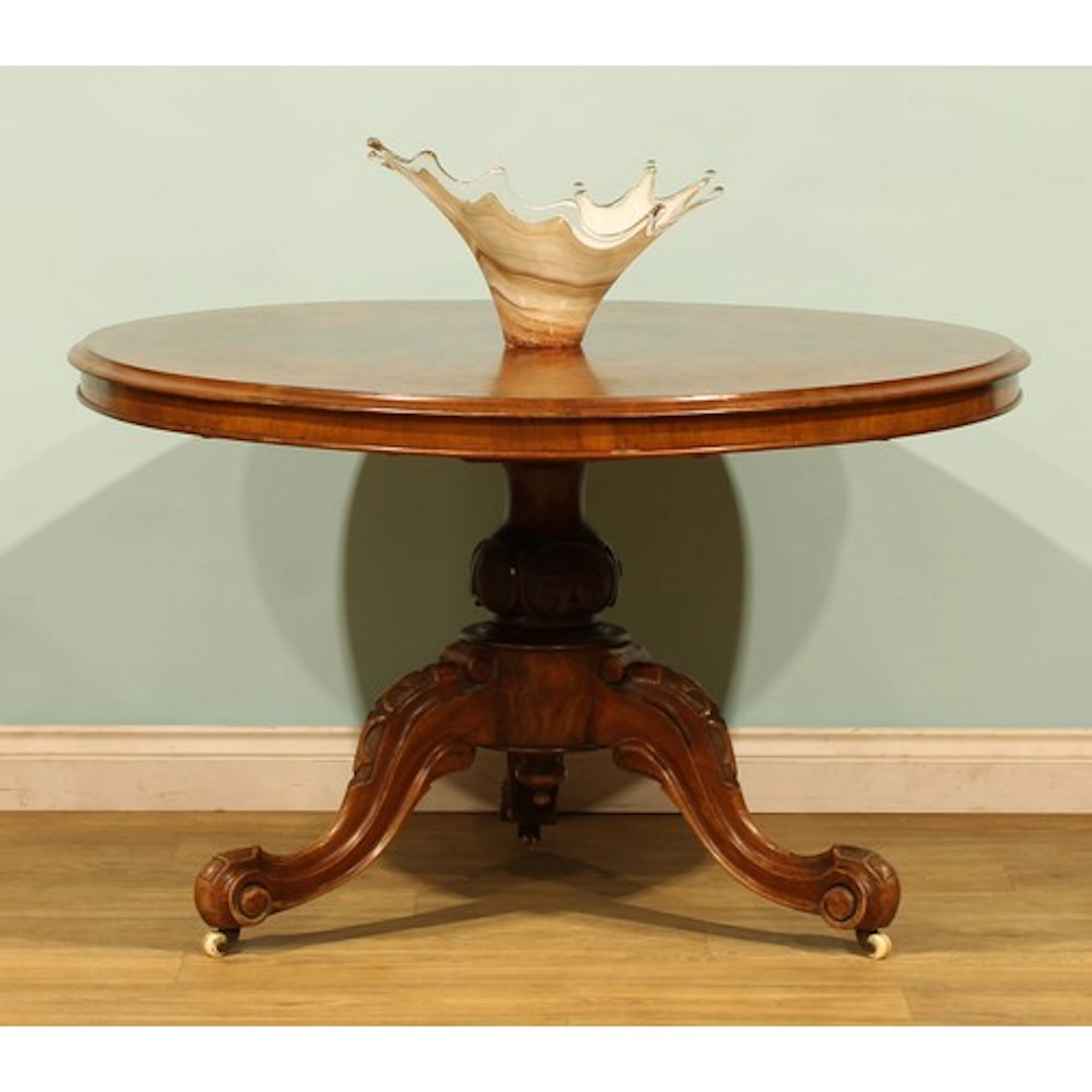 A Victorian walnut centre table, circular tilting top, balus...