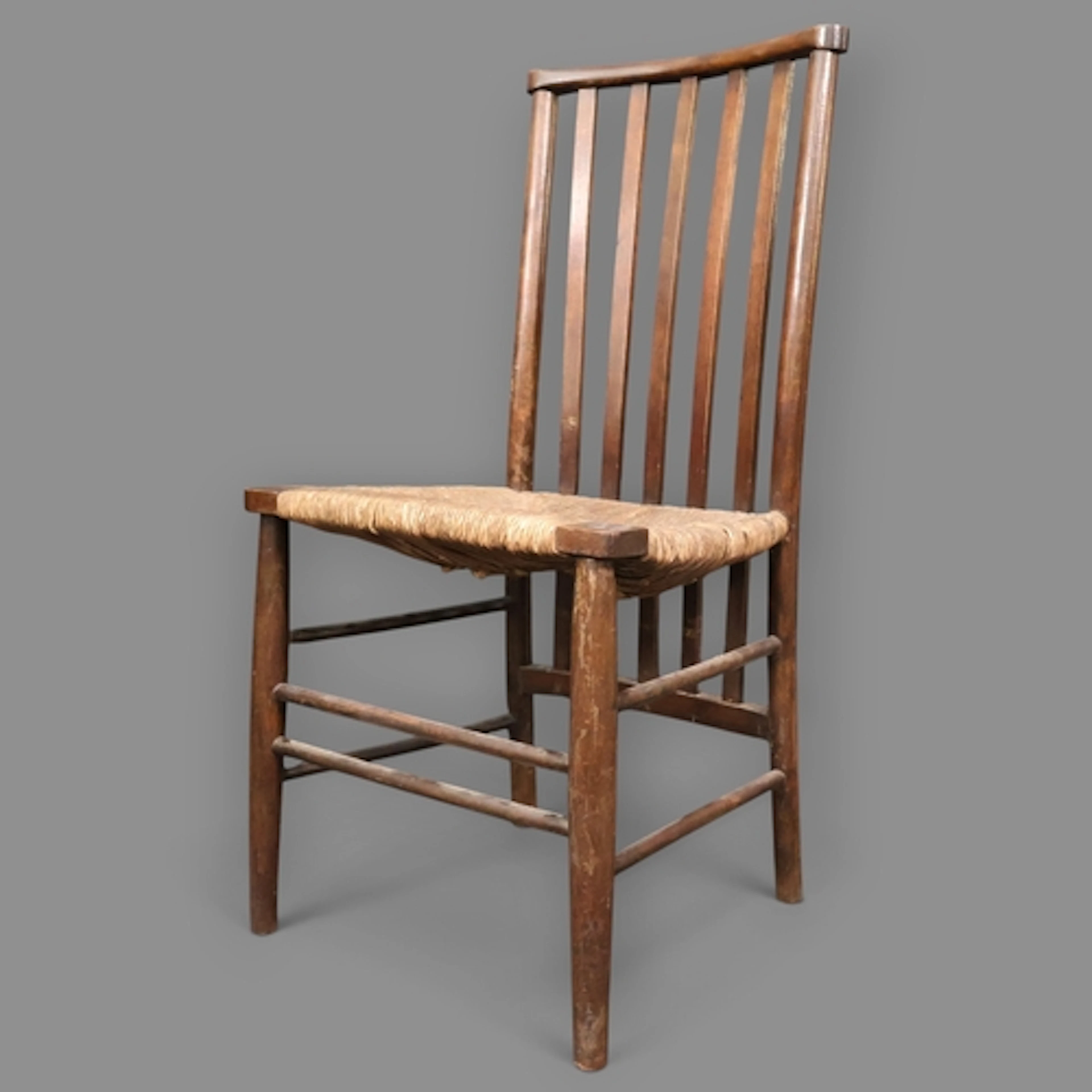 An antique oak and mahogany rush seated Sussex chair in the ...