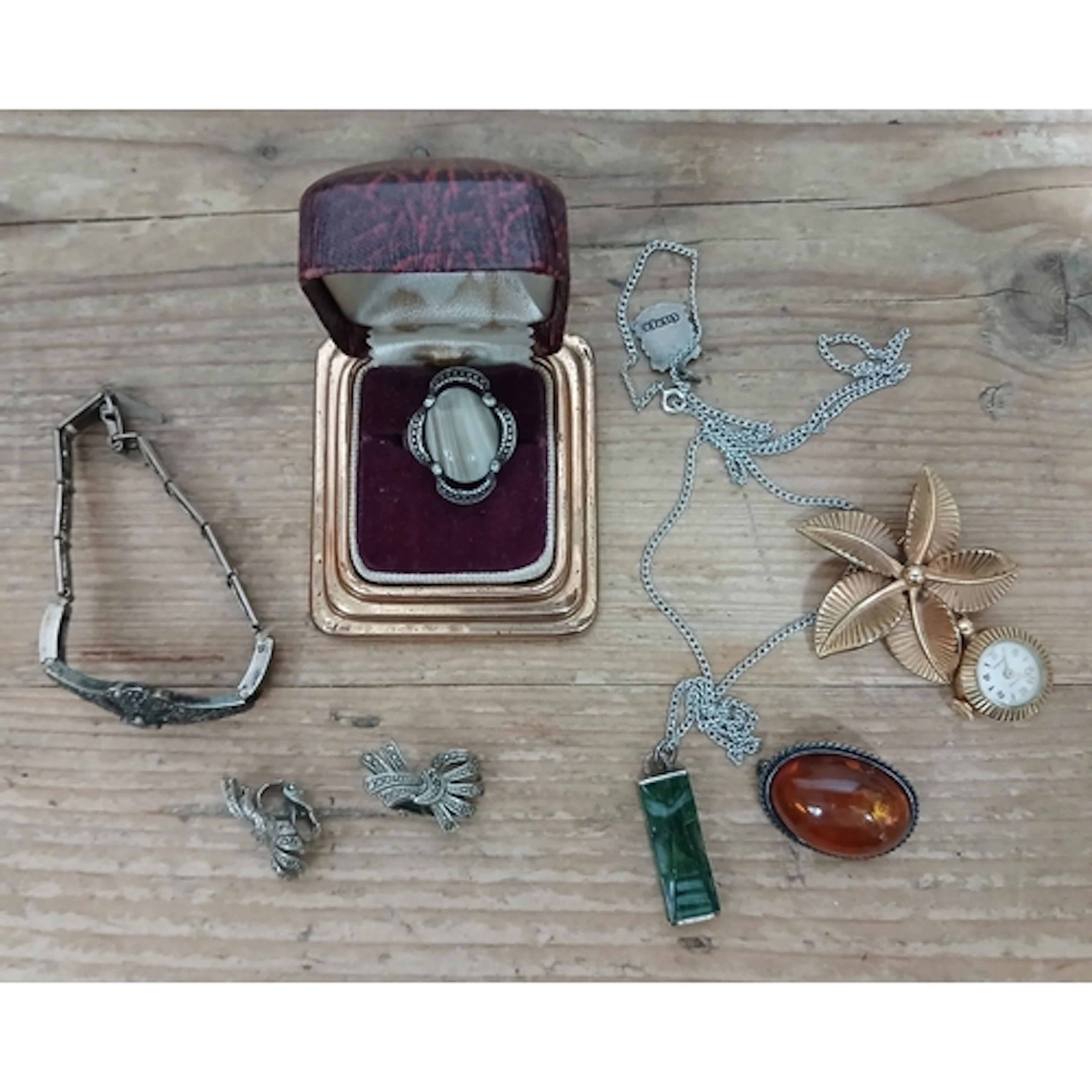 A mixed lot comprising a gold plated lapel watch, amber cabo...