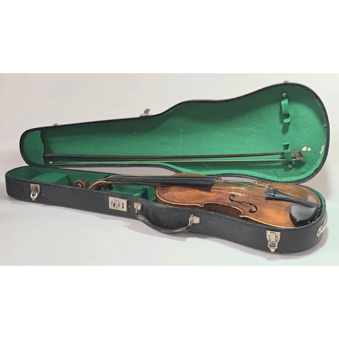 An antique violin in period fitted case c/w bow. Some restor...