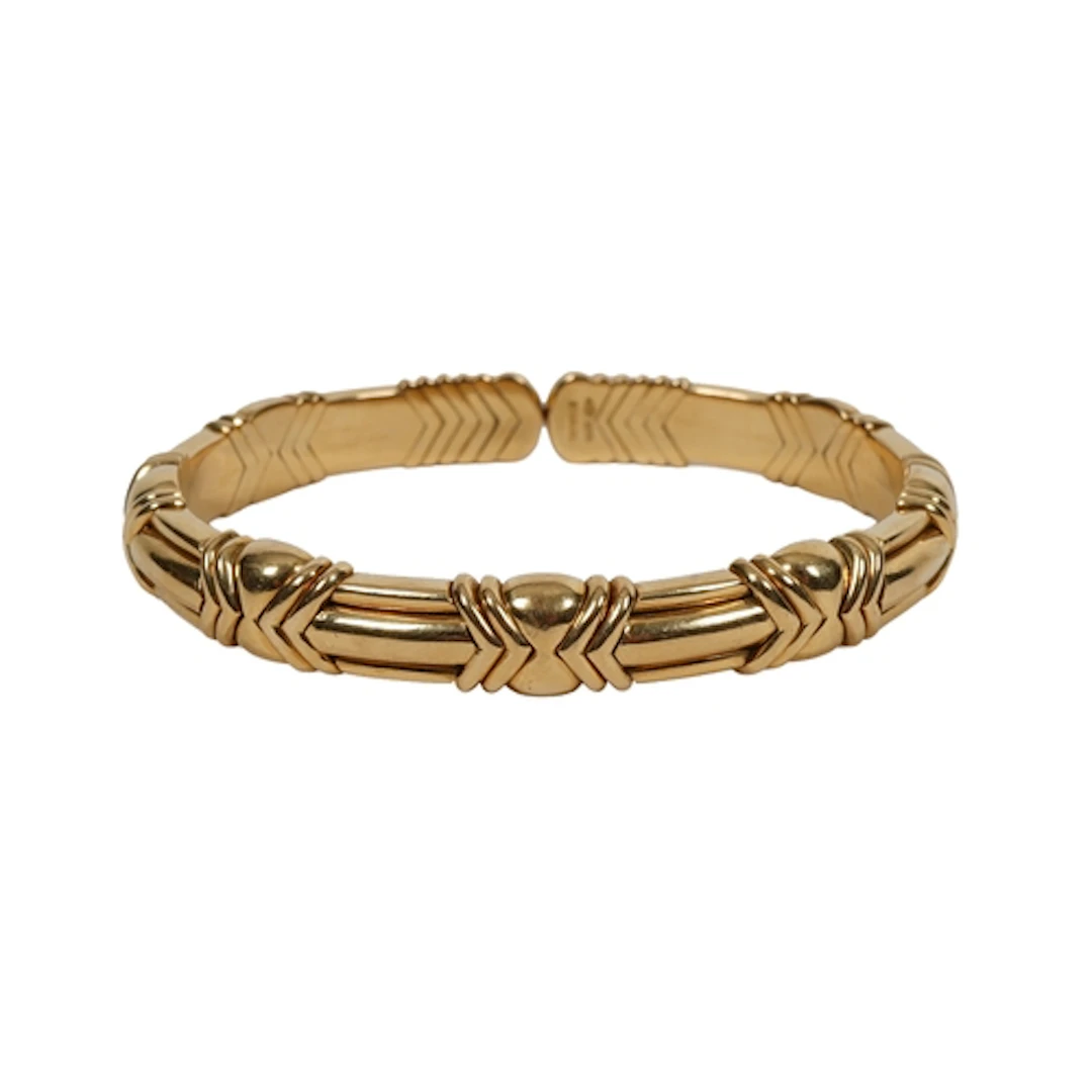 Bulgari, a gold bangle, of flexible design, composed of modu...
