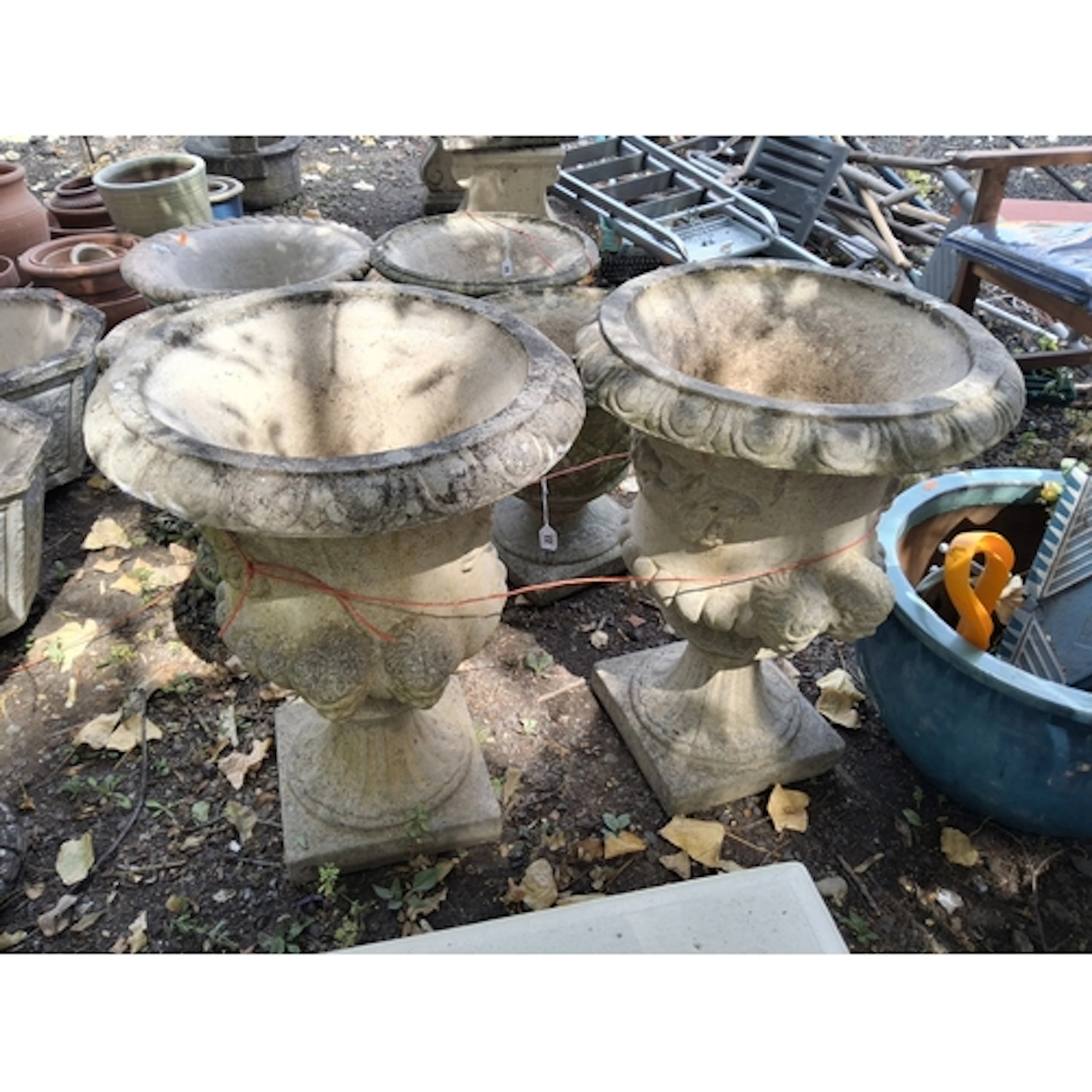 A PAIR OF CONCRETE GARDEN URNS constructed in two pieces wit...