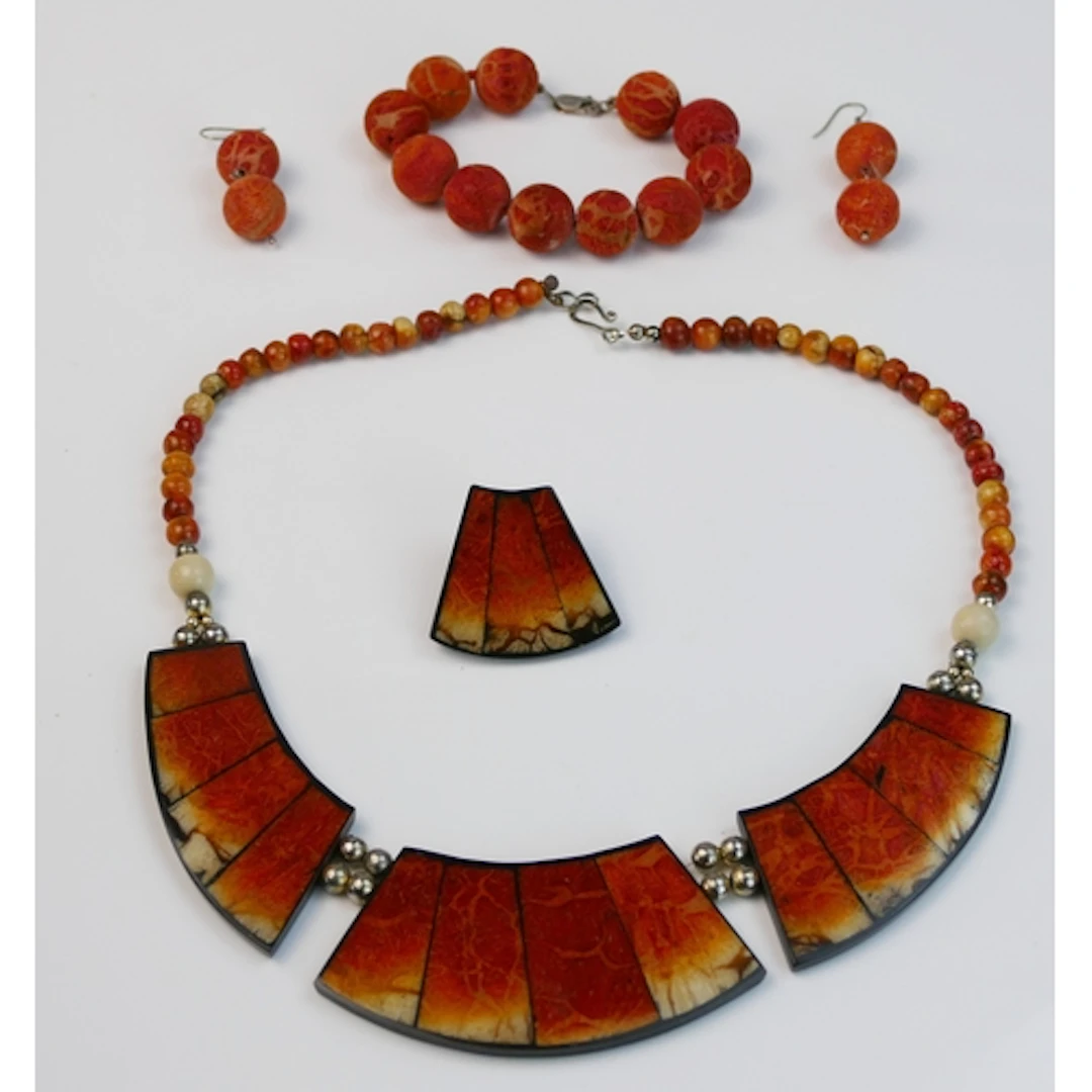 Lee Sands - a carved coral necklace, 49cm long, and matching...