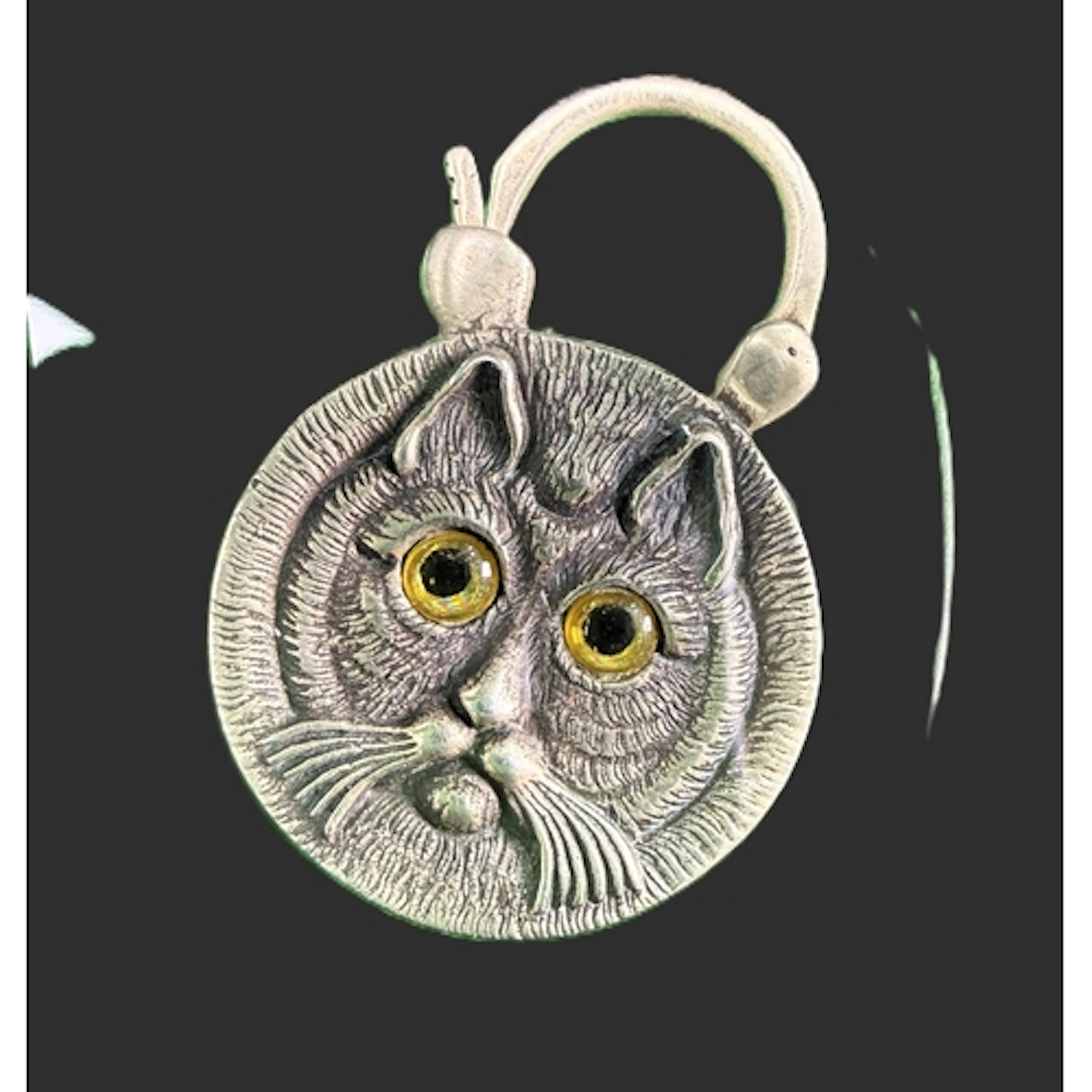 A novelty white metal lock in the form of a cat's face with ...