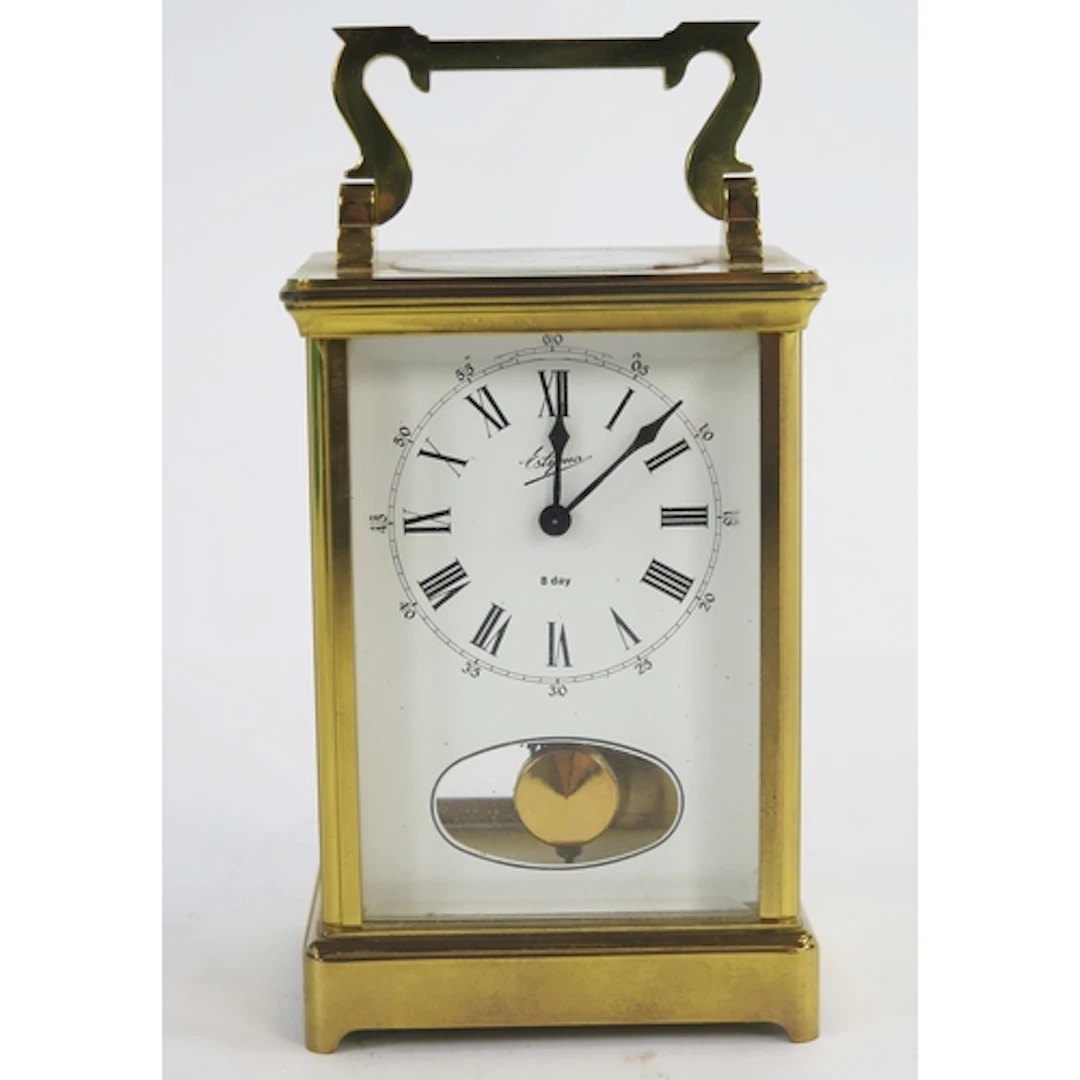 A lacquered brass carriage clock, the movement striking to a...