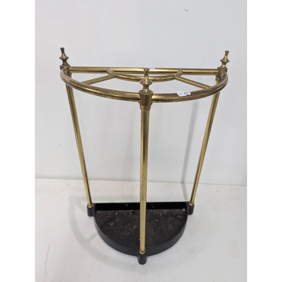 A demi-lune brass and cast-iron umbrella/walking stick stand...