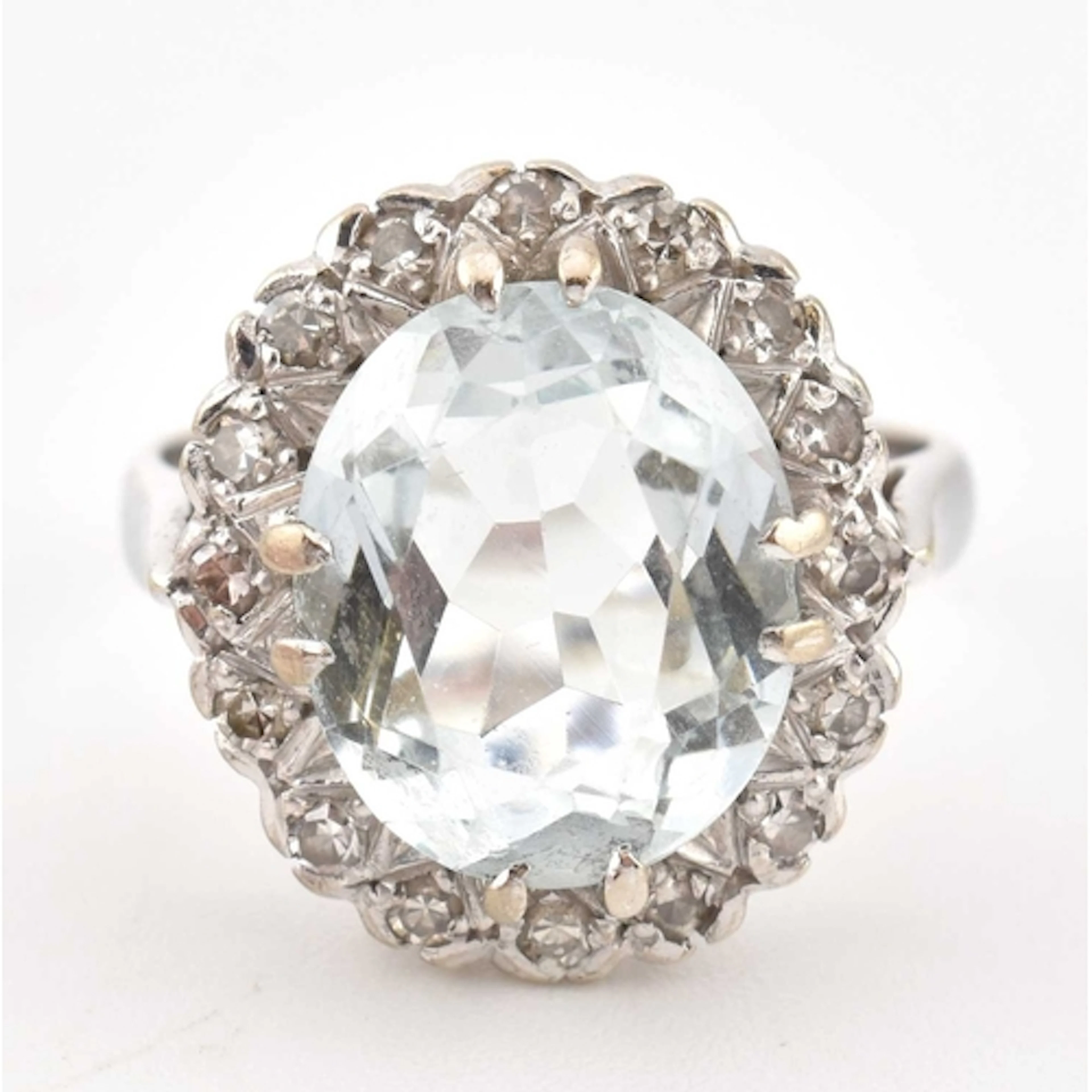 A 1970s hallmarked 18ct gold aquamarine and diamond halo rin...