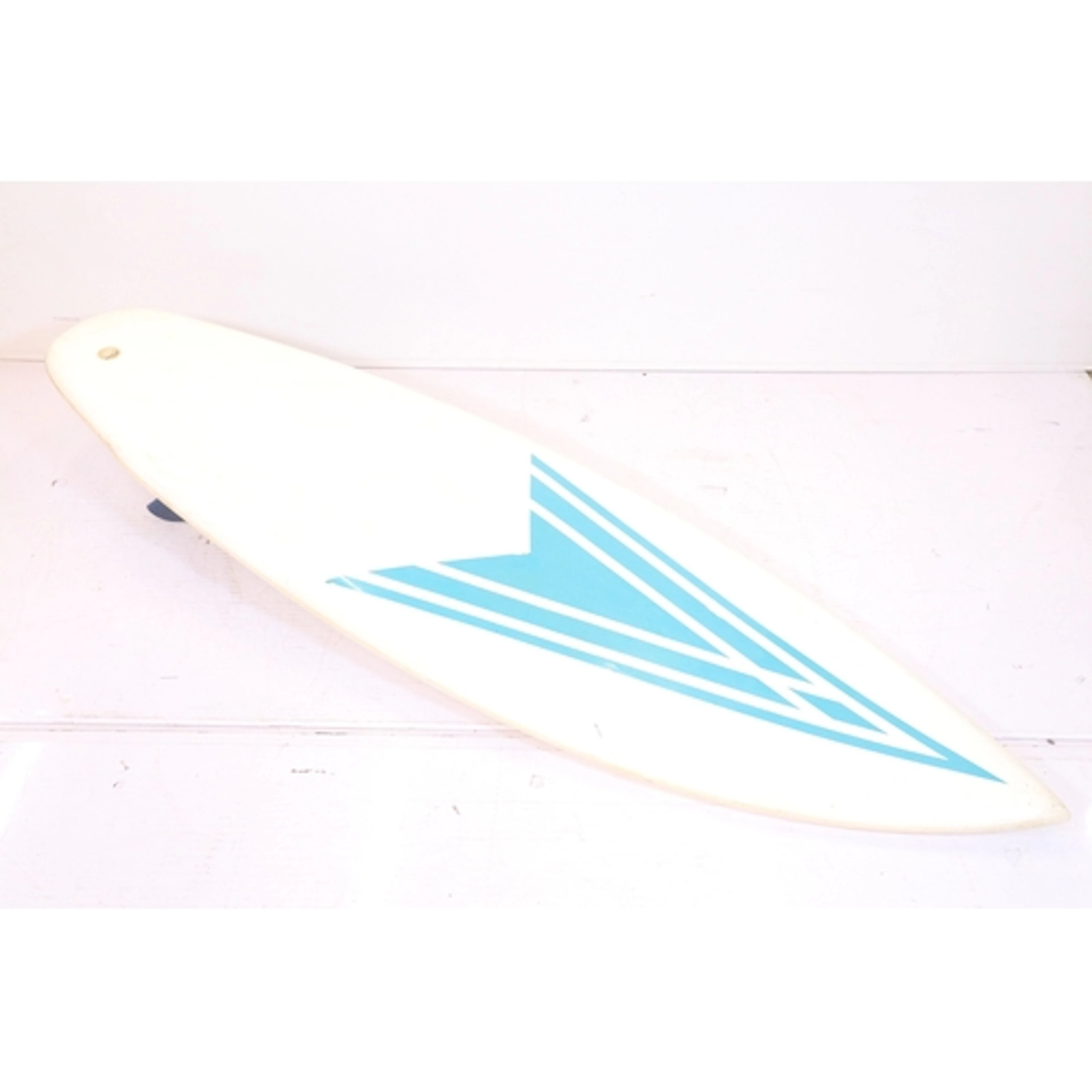 Surfboard having teal/blue geometric arrow design on a white...