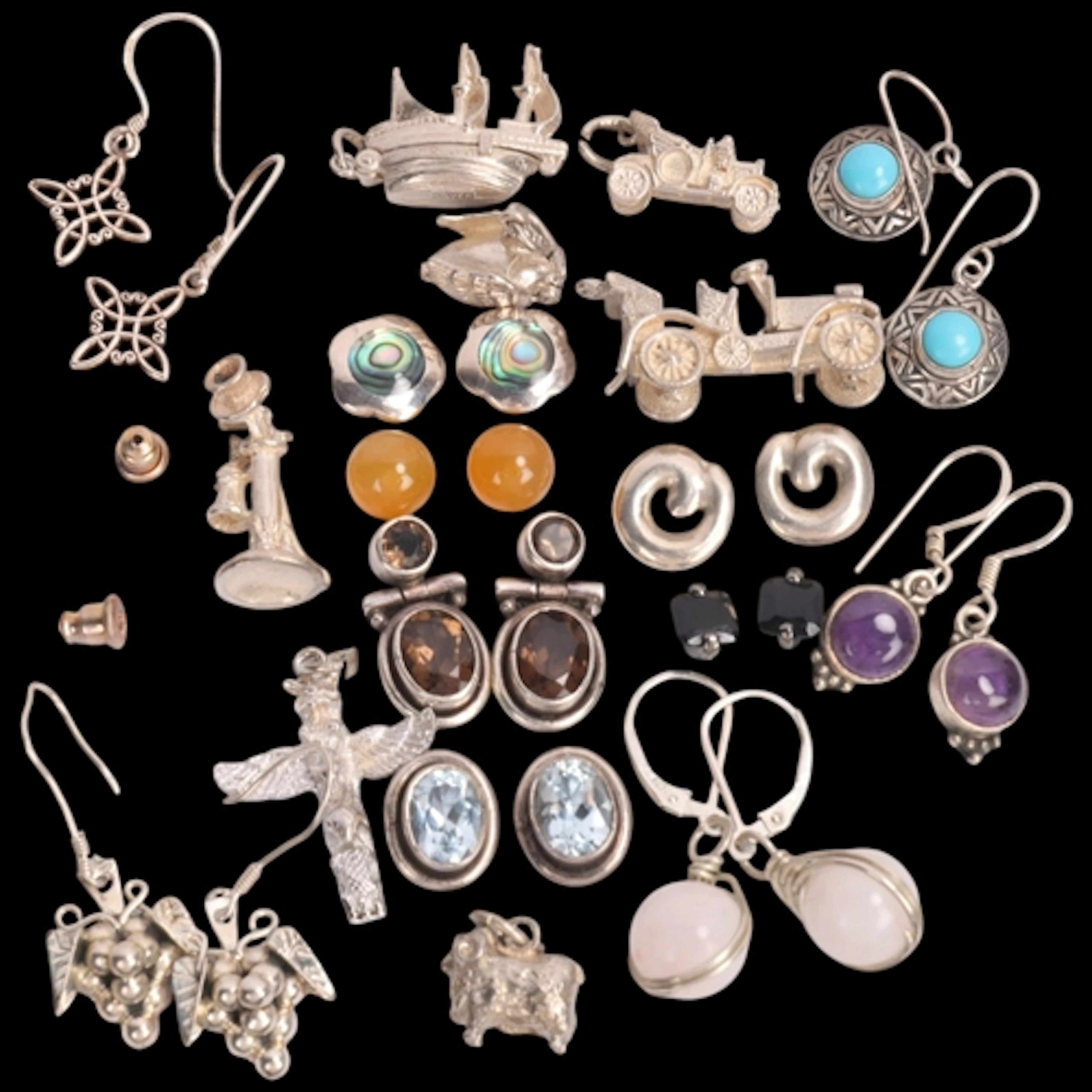 Various silver earrings and charms, including novelty Classi...