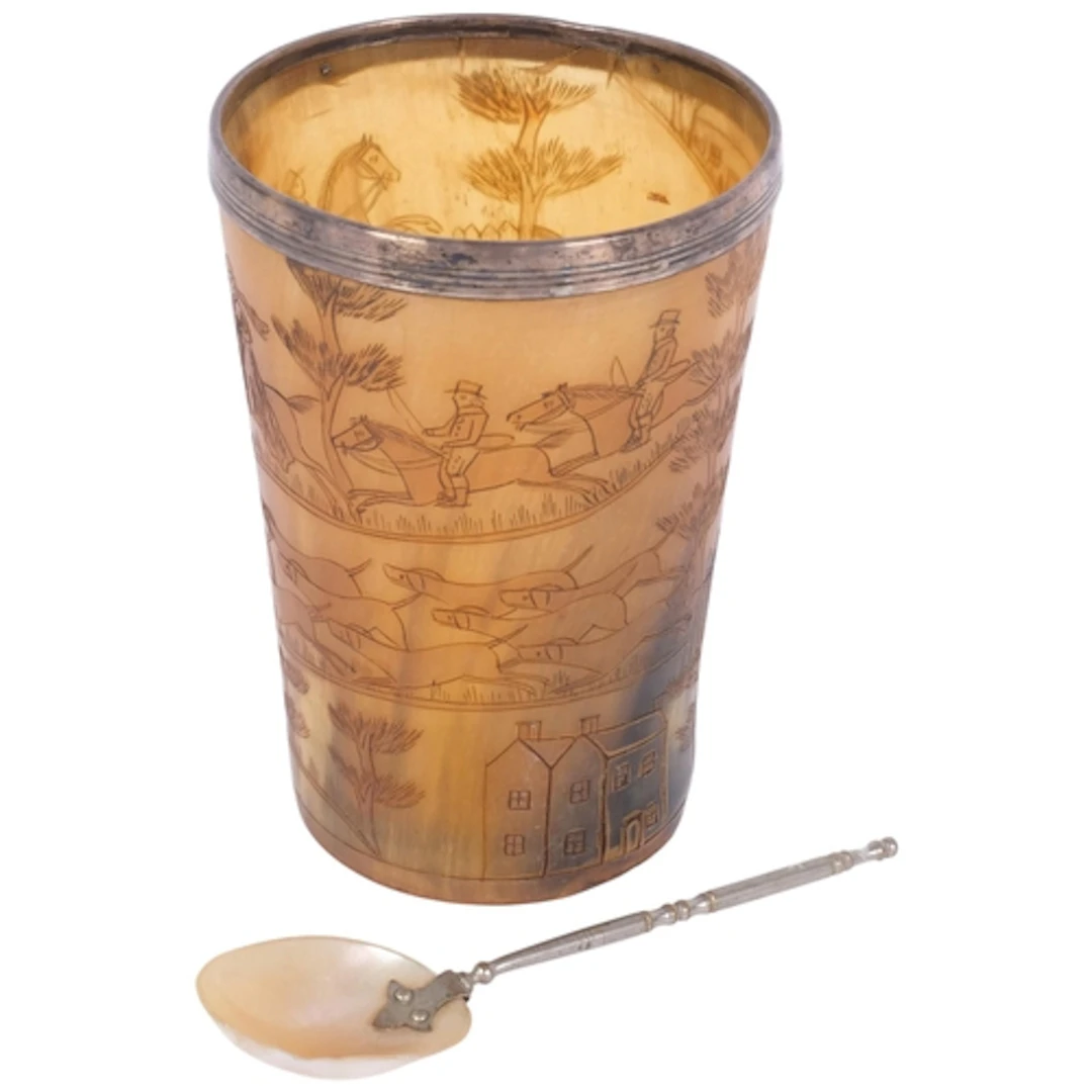 A Victorian carved horn hunting cup, with silver rim, monogr...